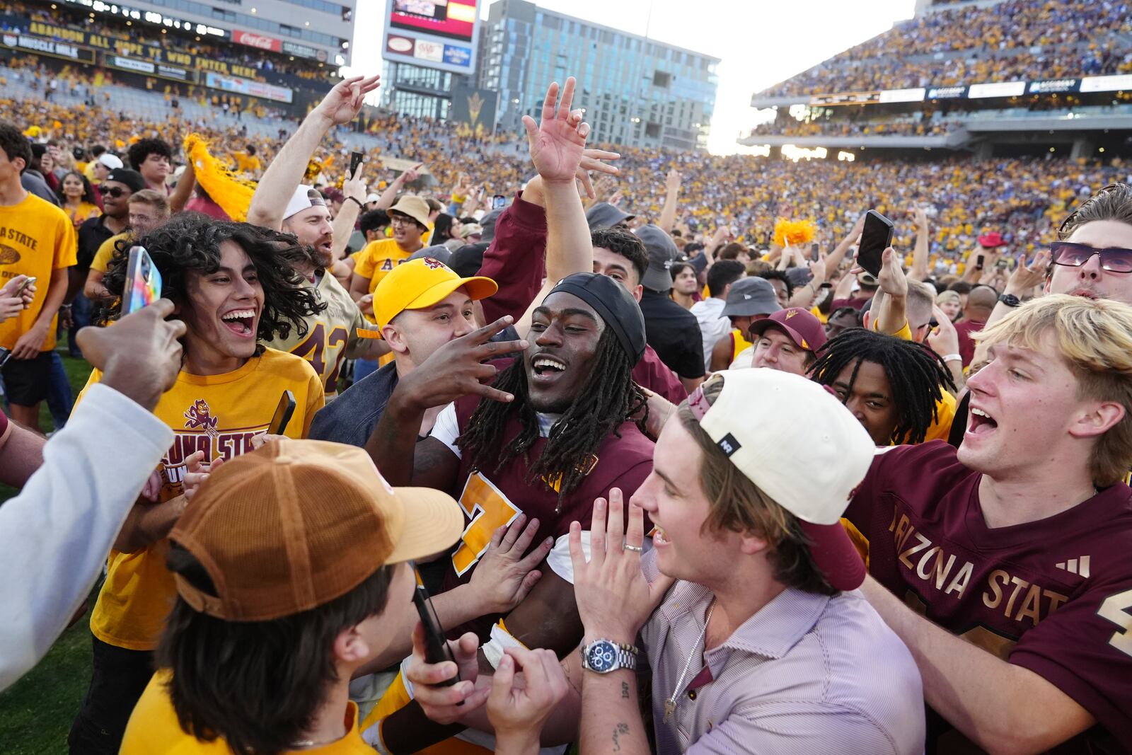 Arizona State defensive back Shamari Simmons, center, celebrates with fans following a 28-23 win over BYU in an NCAA college football game Saturday, Nov. 23, 2024, in Tempe, Ariz. (AP Photo/Ross D. Franklin)