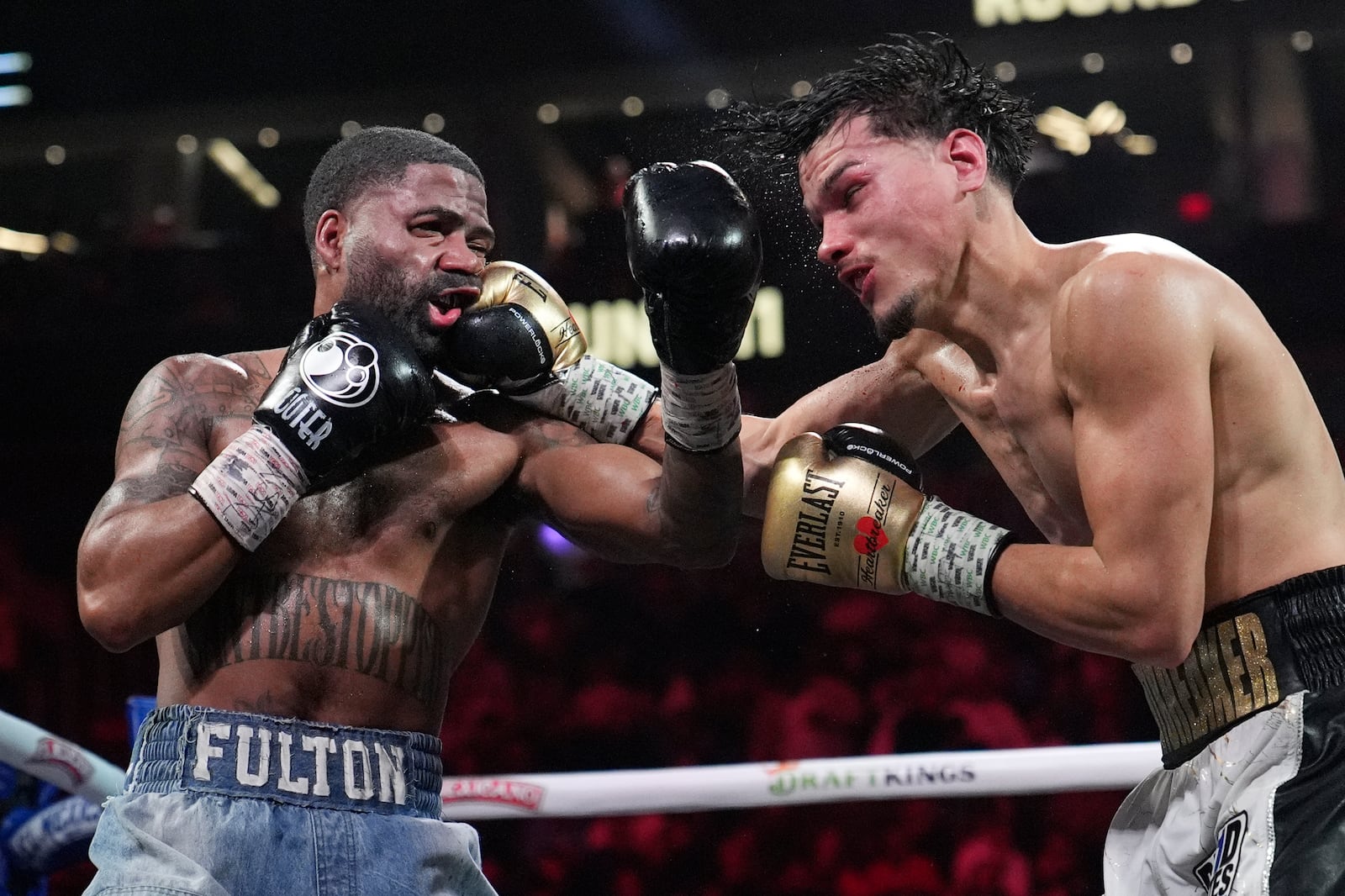 Brandon Figueroa, right, exchanges blows with Stephen Fulton Jr. in a featherweight title boxing match Saturday, Feb. 1, 2025, in Las Vegas. (AP Photo/John Locher)