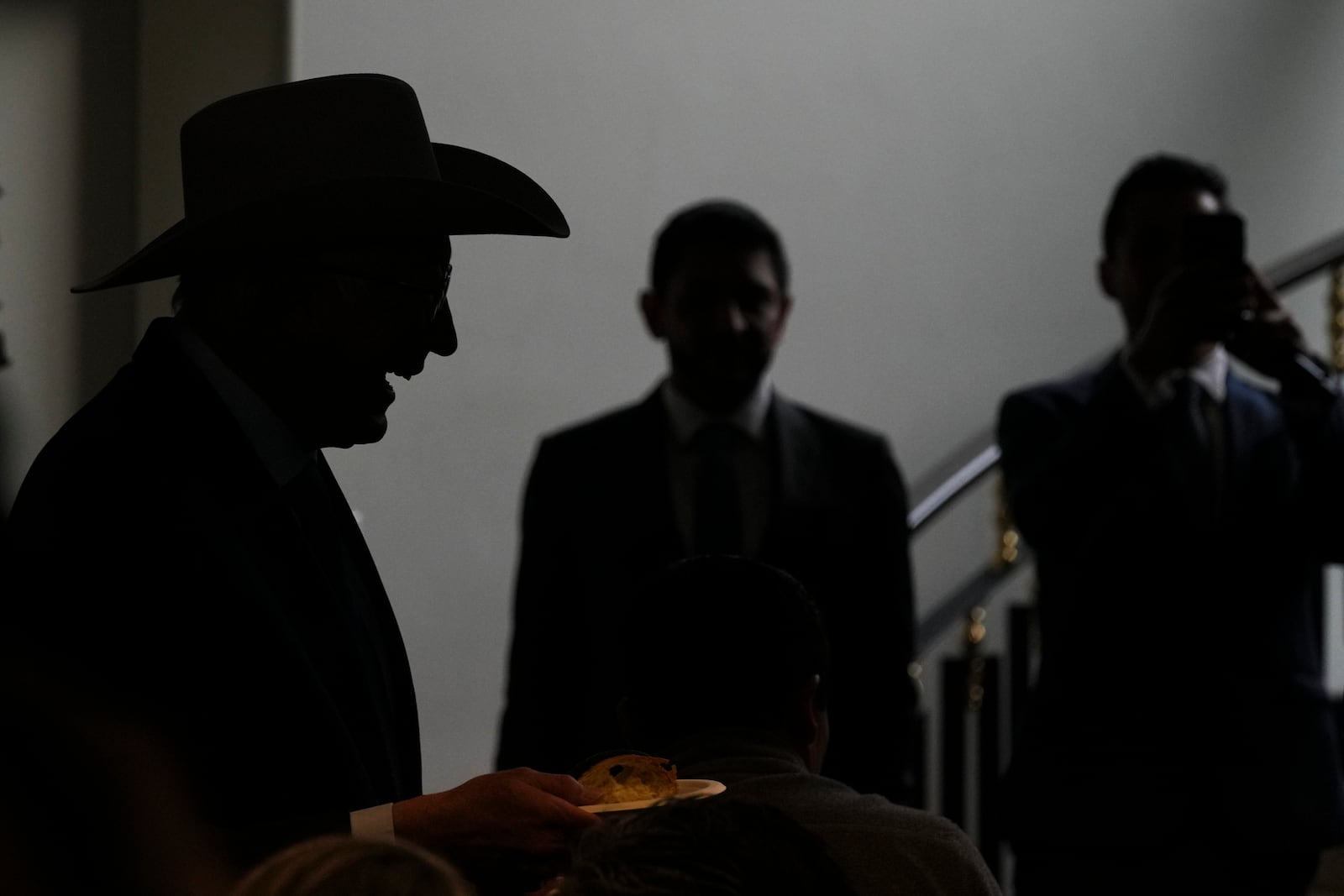 Outgoing U.S. Ambassador to Mexico Ken Salazar shares a piece of the traditional Rosca de Reyes bread with media members during his farewell news conference in Mexico City, Monday, Jan. 6, 2025. (AP Photo/Fernando Llano)