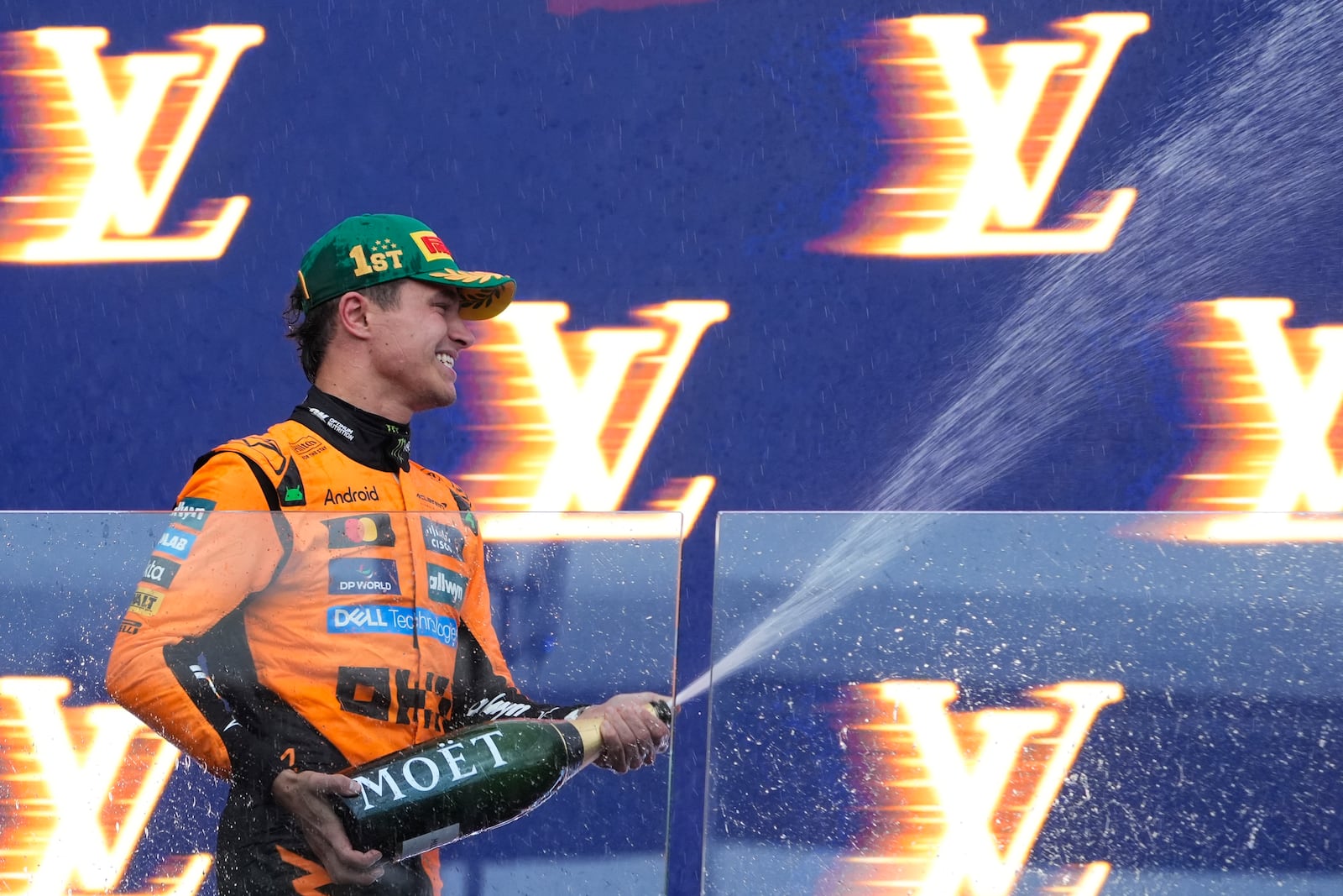 McLaren driver Lando Norris of Britain celebrates on the podium after winning the Australian Formula One Grand Prix at Albert Park, in Melbourne, Australia, Sunday, March 16, 2025. (AP Photo/Asanka Brendon Ratnayake)