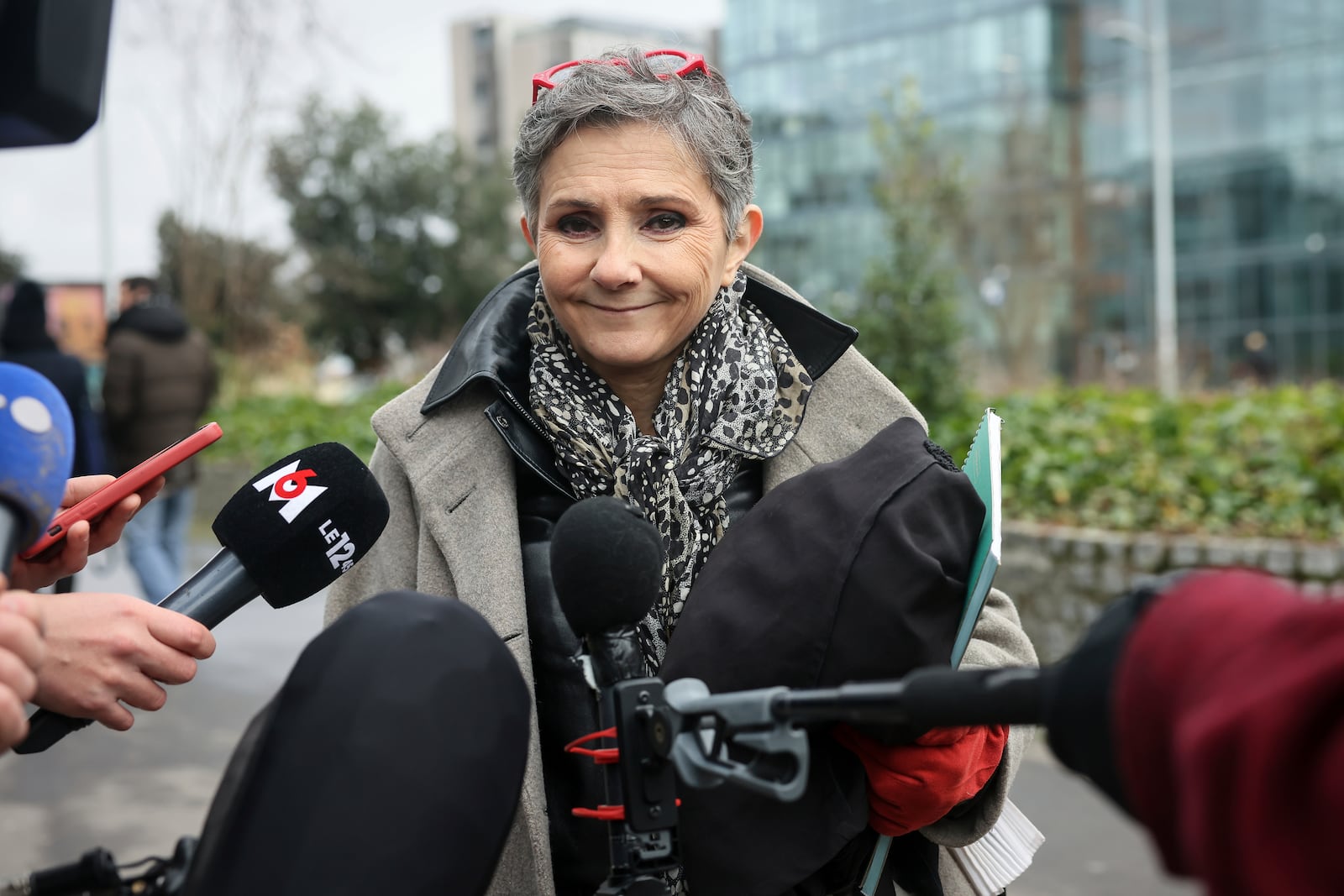 Dominique Pelicot 's lawyer Beatrice Zavarro answers reporters outside the Nanterre courthouse where the convicted rapist who horrified France by drugging his then wife, Gisele Pélicot, so other men could rape her, is now caught up in other cases, Thursday, Jan. 30, 2025 in Nanterre, outside Paris. (AP Photo/Thomas Padilla)