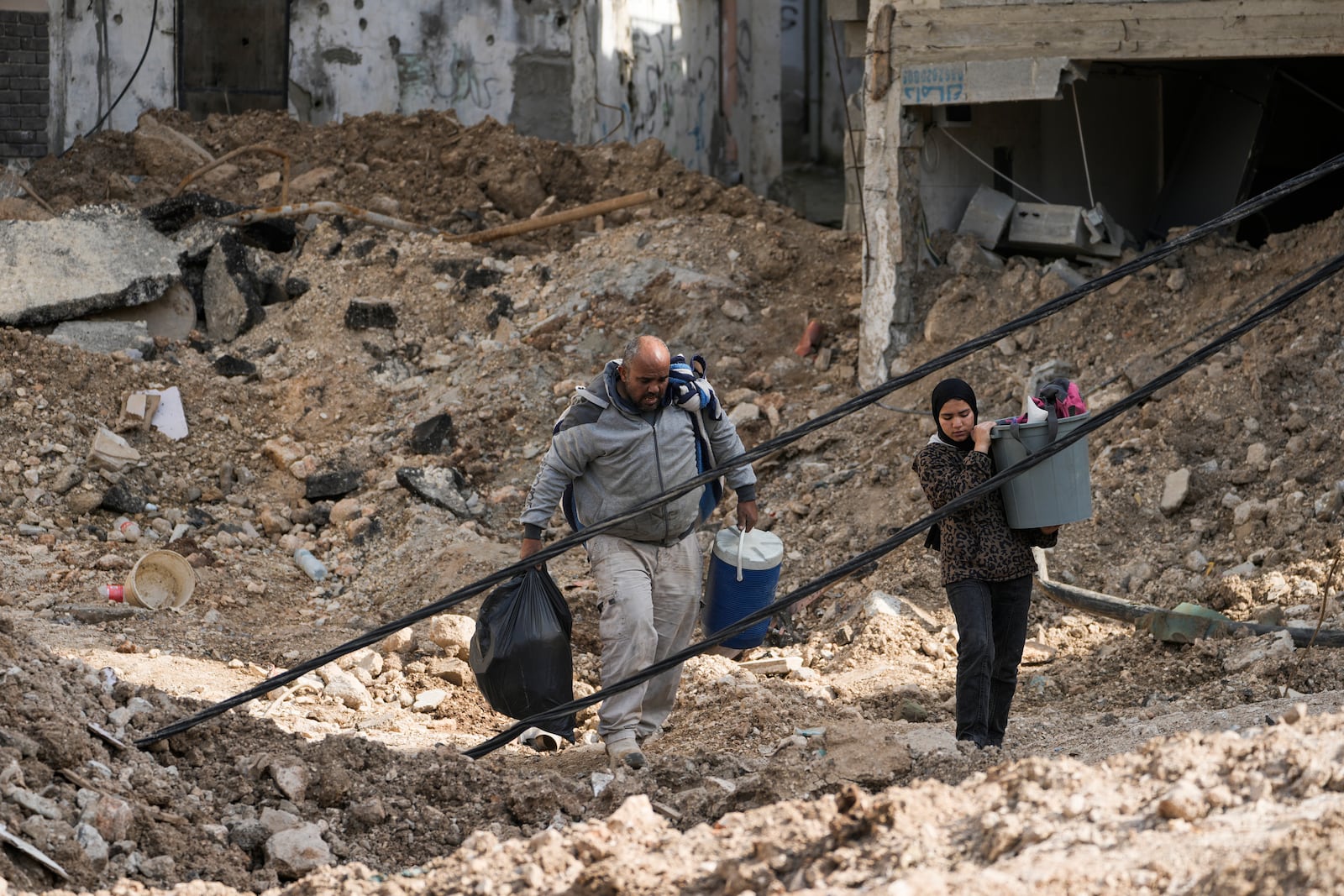 Residents of the West Bank urban refugee camp of Nur Shams evacuate their homes and carry their belongings as the Israeli military continues its operation in the area on Wednesday, March 5, 2025. (AP Photo/Majdi Mohammed)