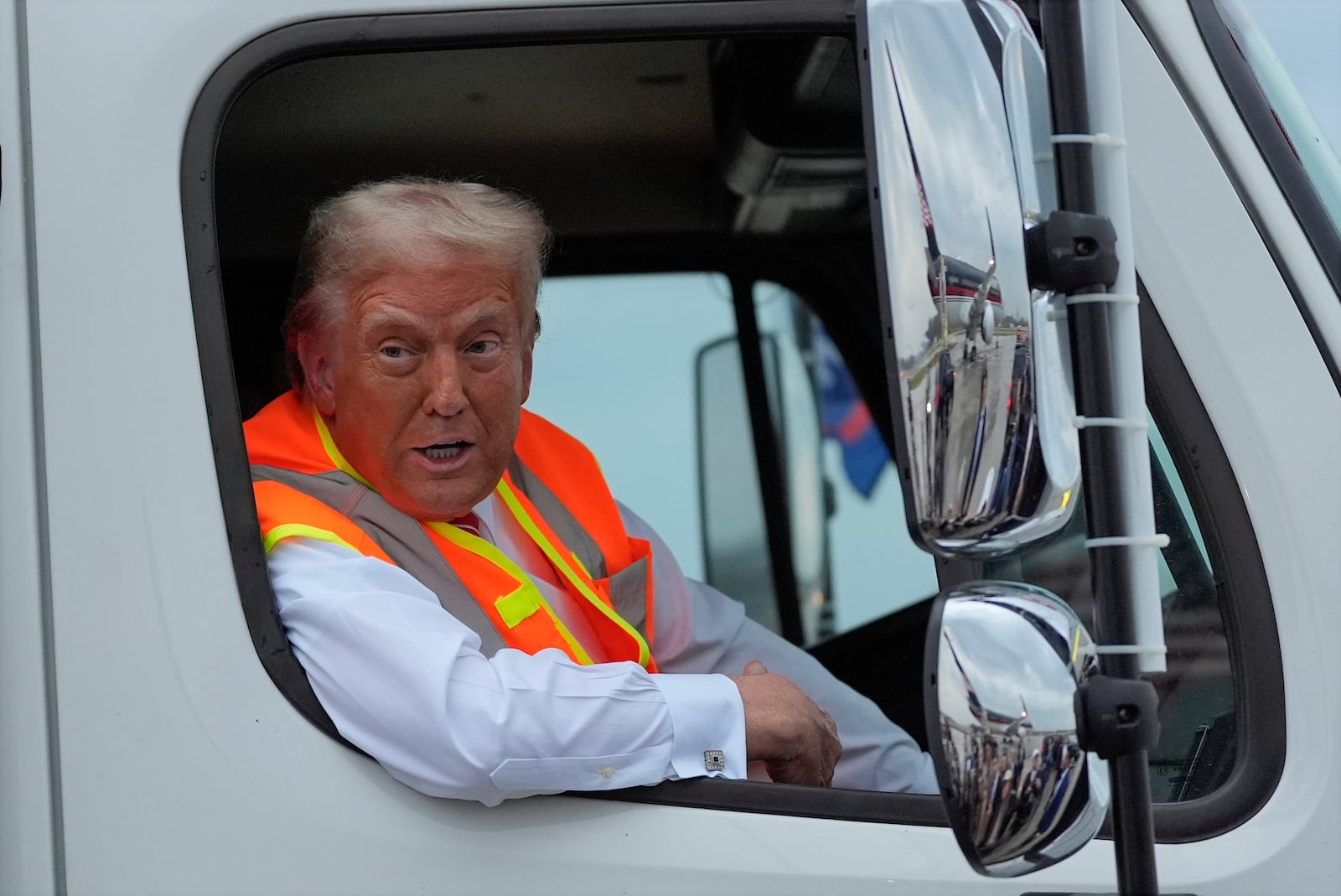 Republican presidential nominee former President Donald Trump talks to reporters as he sits in a garbage truck Wednesday, Oct. 30, 2024, in Green Bay, Wis. (AP Photo/Julia Demaree Nikhinson)