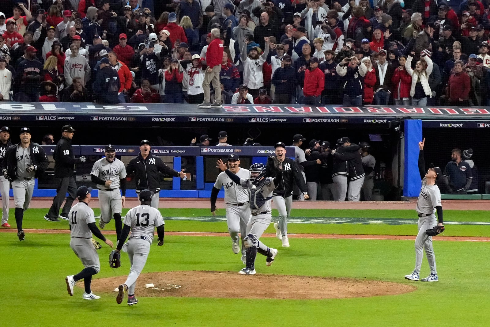 New York Yankees players celebrate after Game 5 of the baseball AL Championship Series against the Cleveland Guardians Saturday, Oct. 19, 2024, in Cleveland. The Yankees won 5-2 to advance to the World Series. (AP Photo/Jeff Roberson)