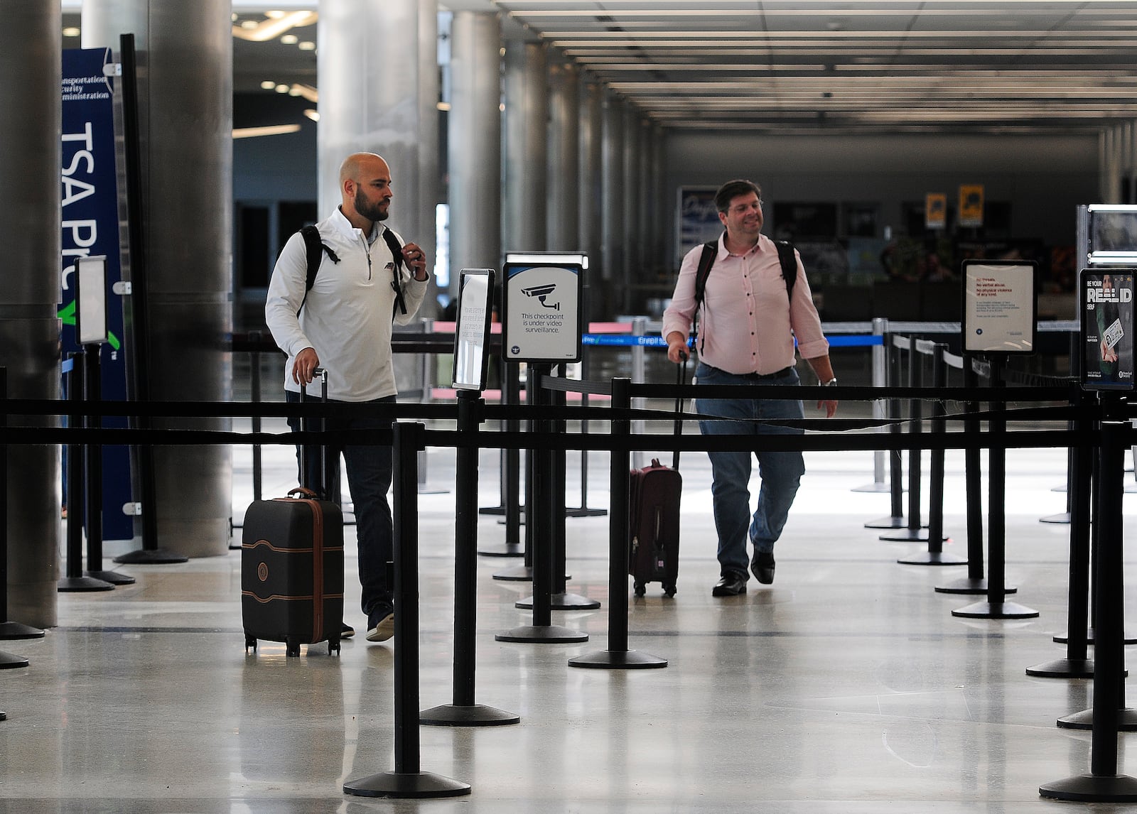 Travelers walk through Dayton International Airport Thursday, June 27, 2024. The airport will be busy for Independence Day week as travel nationwide is expected to be 5% greater than in 2023 and 8% greater than 2019. MARSHALL GORBY/STAFF