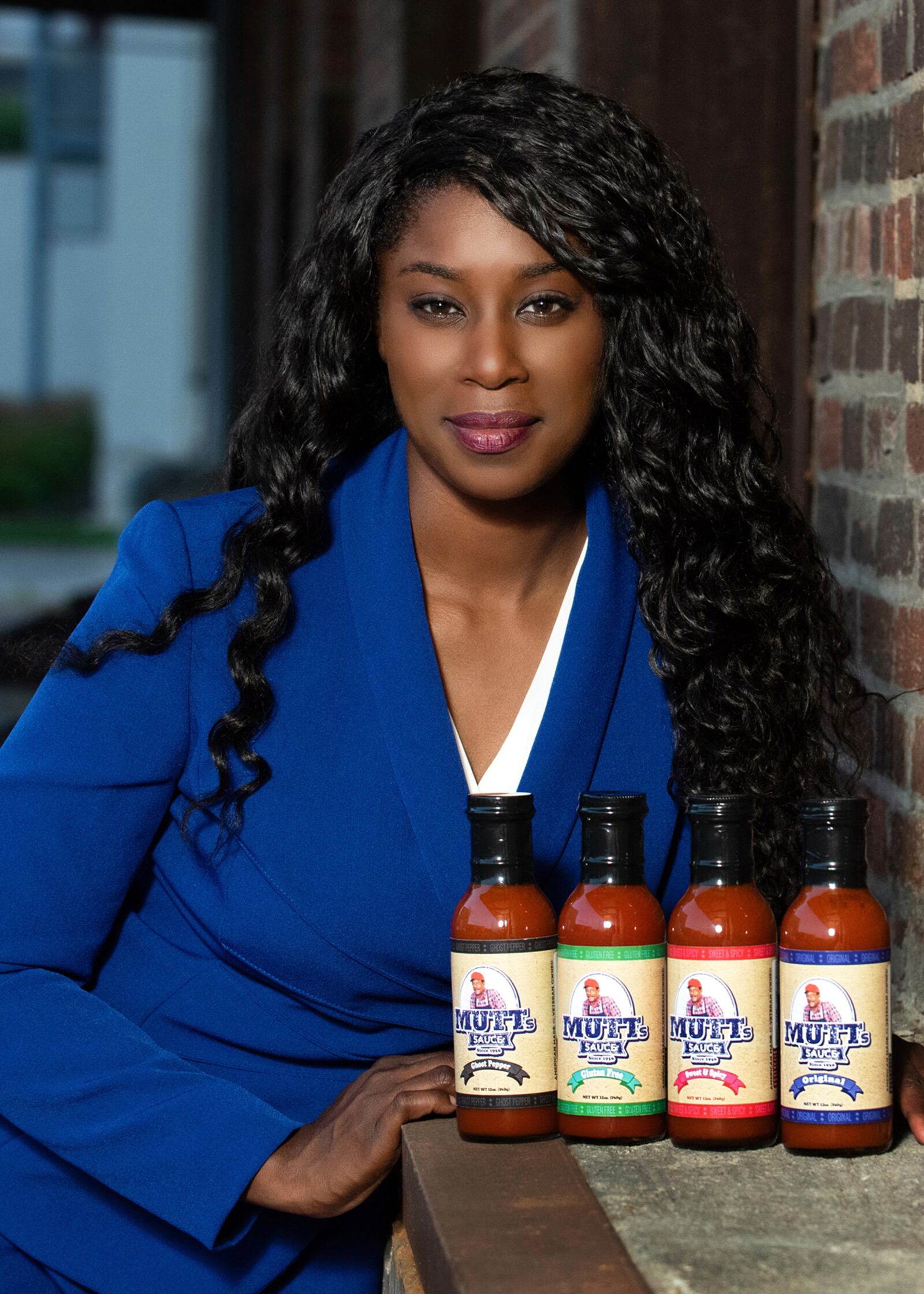 Charlynda Scales is shown with four flavors of her family recipe multi-purpose sauce, originally developed by her grandfather, Charlie "Mutt" Ferrell, Jr. CONTRIBUTED