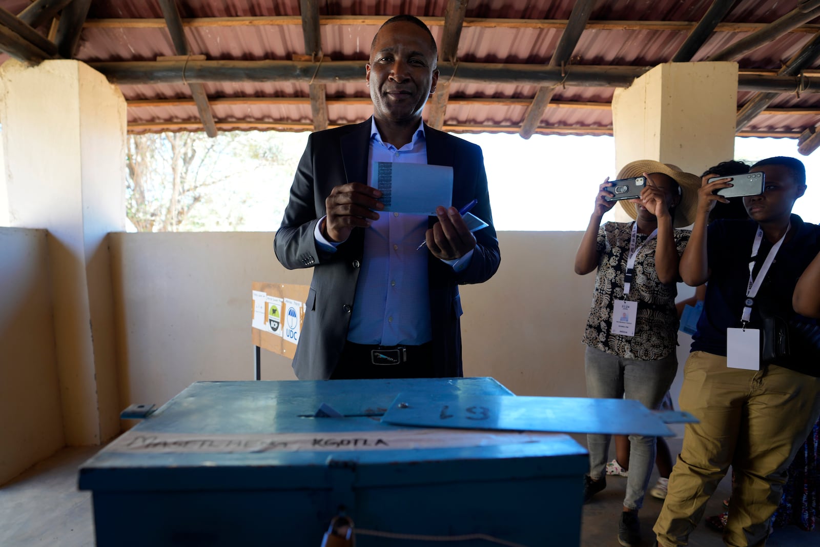 Umbrella for Democratic Change (UDC) presidential candidate Duma Boko holds his ballot paper before inserting it into the box during the elections in Gaborone, Botswana, Wednesday, Oct. 30, 2024. (AP Photo/Themba Hadebe)