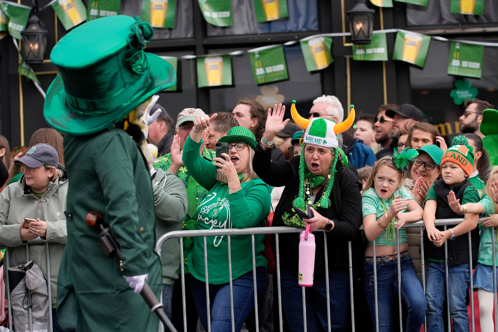 Michele Hunter, of Pawlet, Vt., center left, and Erin Riley, of Saugus, Mass., cheer a performer at the St. Patrick's Day parade, Sunday, March 16, 2025, in Boston, Mass. (AP Photo/Robert F. Bukaty)