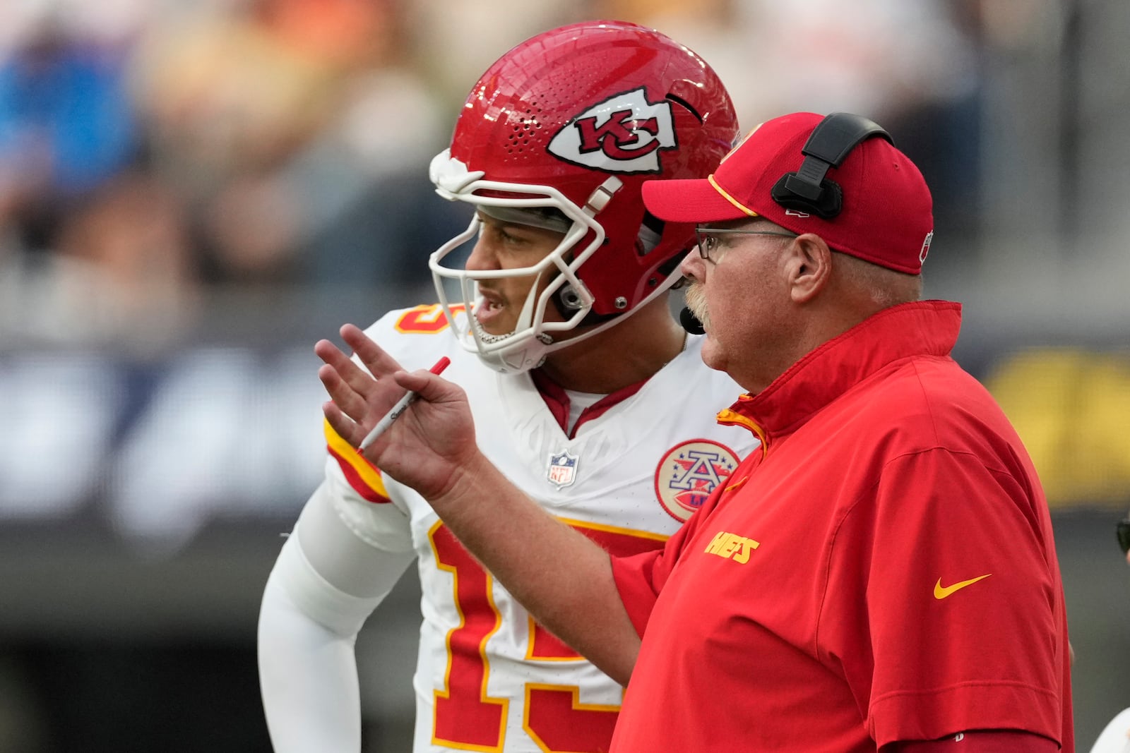 Kansas City Chiefs quarterback Patrick Mahomes, left, talks with head coach Andy Reid during the second half of an NFL football game against the Los Angeles Chargers Sunday, Sept. 29, 2024, in Inglewood, Calif. (AP Photo/Ashley Landis)