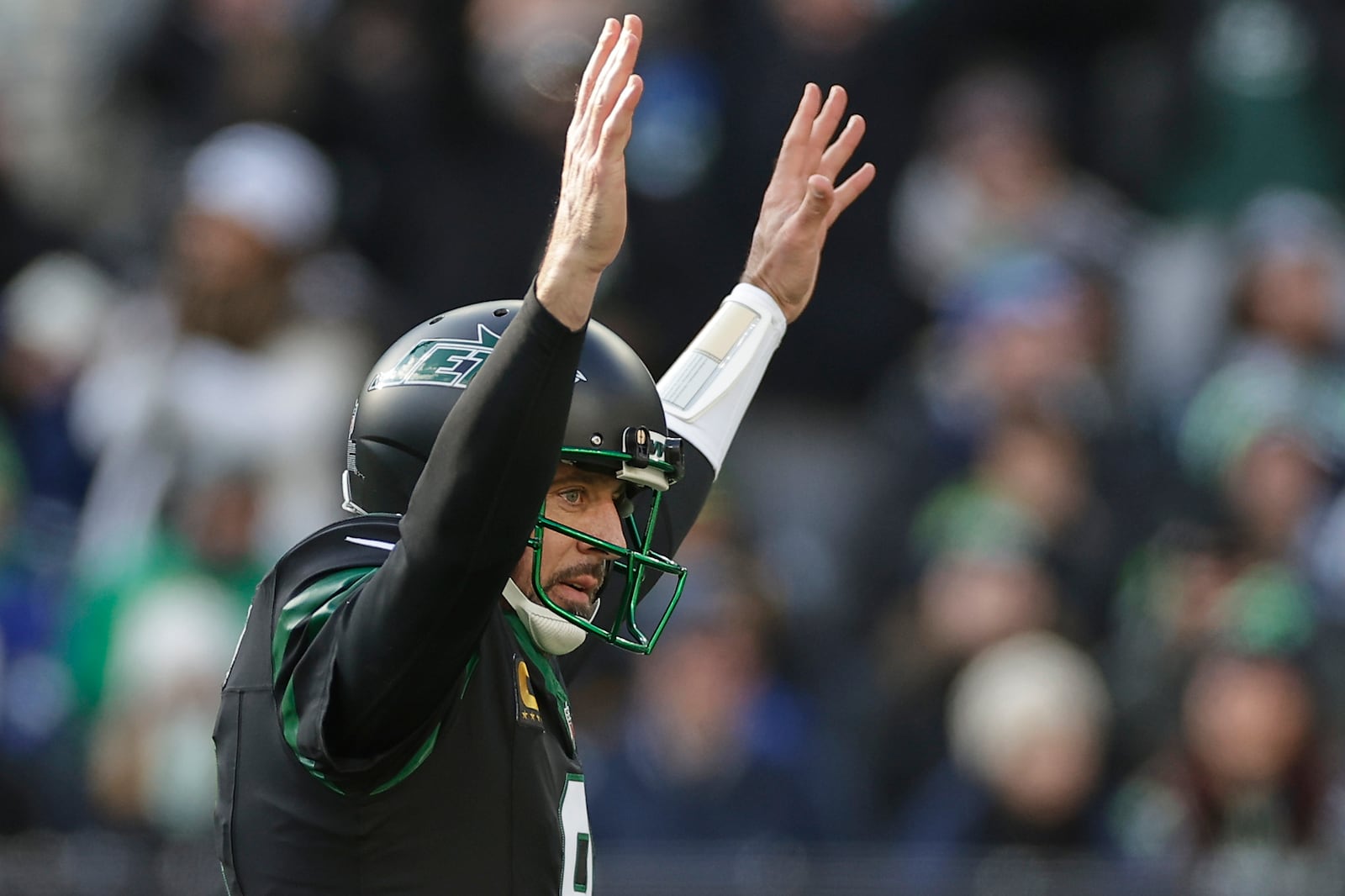 New York Jets quarterback Aaron Rodgers (8) reacts after throwing a touchdown pass against the Seattle Seahawks during the first quarter of an NFL football game, Sunday, Dec. 1, 2024, in East Rutherford, N.J. (AP Photo/Adam Hunger)