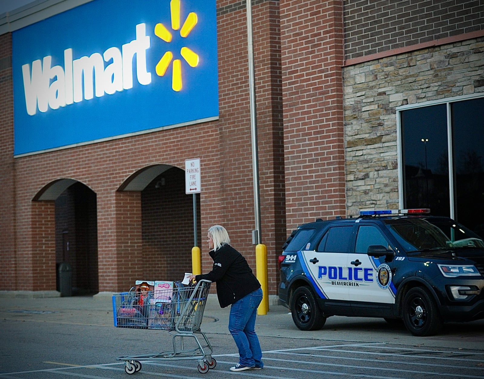 Five police cruisers sit outside the Beavercreek Walmart store on Black Friday, November 24, 2023. The store reopened that morning after a shooting there injured four people earlier in the week. MARSHALL GORBY \STAFF