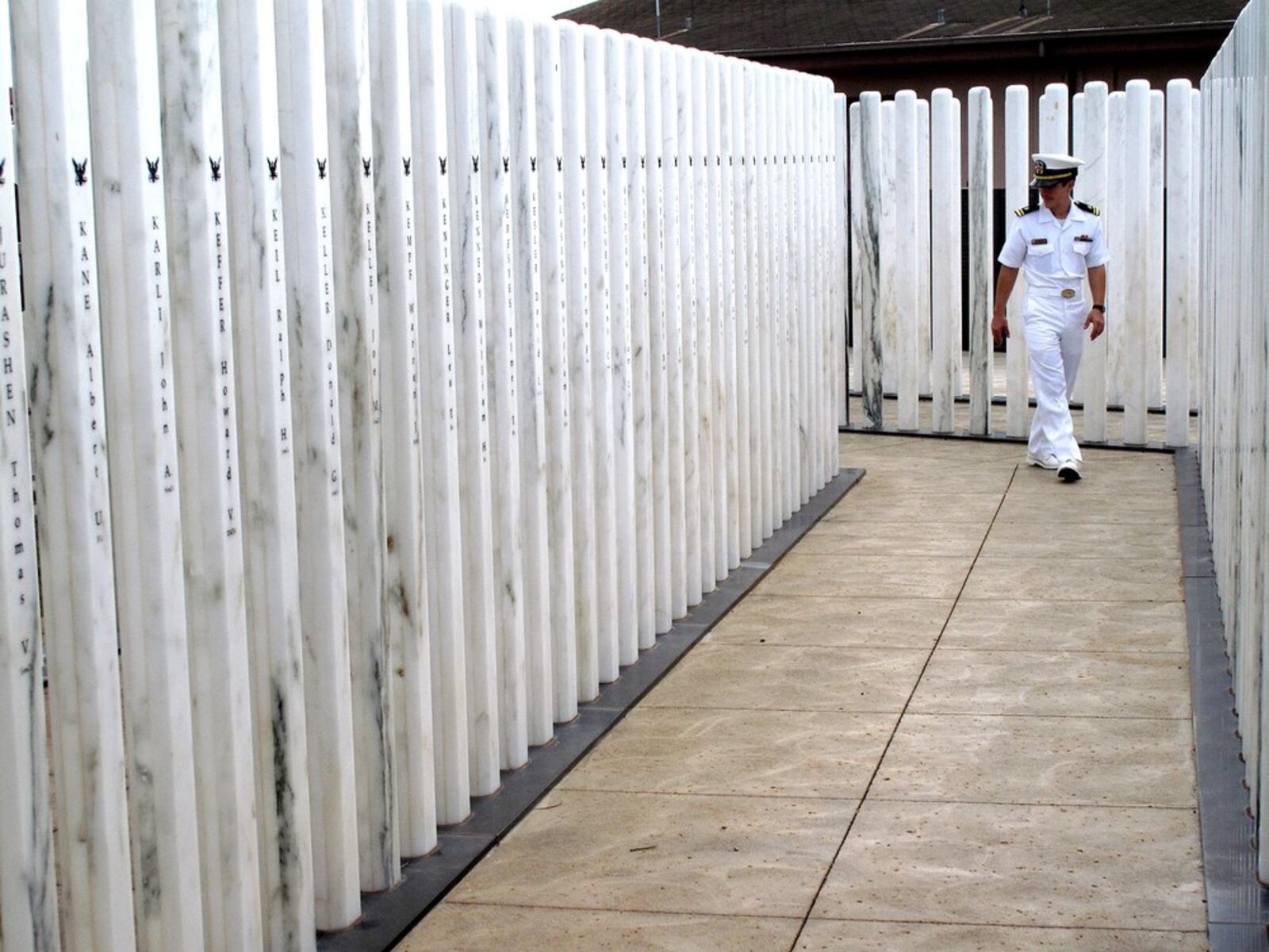 Lt. j.g. Daniel Conley walks through the USS Oklahoma Memorial during a ceremony on Ford Island. The National Park Service hosted a memorial ceremony to commemorate the 68th anniversary of the attack on Pearl Harbor. The USS Oklahoma Memorial honors the 429 men killed aboard Oklahoma Dec. 7, 1941. (U.S. Navy photo by Chief Mass Communication Specialist Bart Bauer)