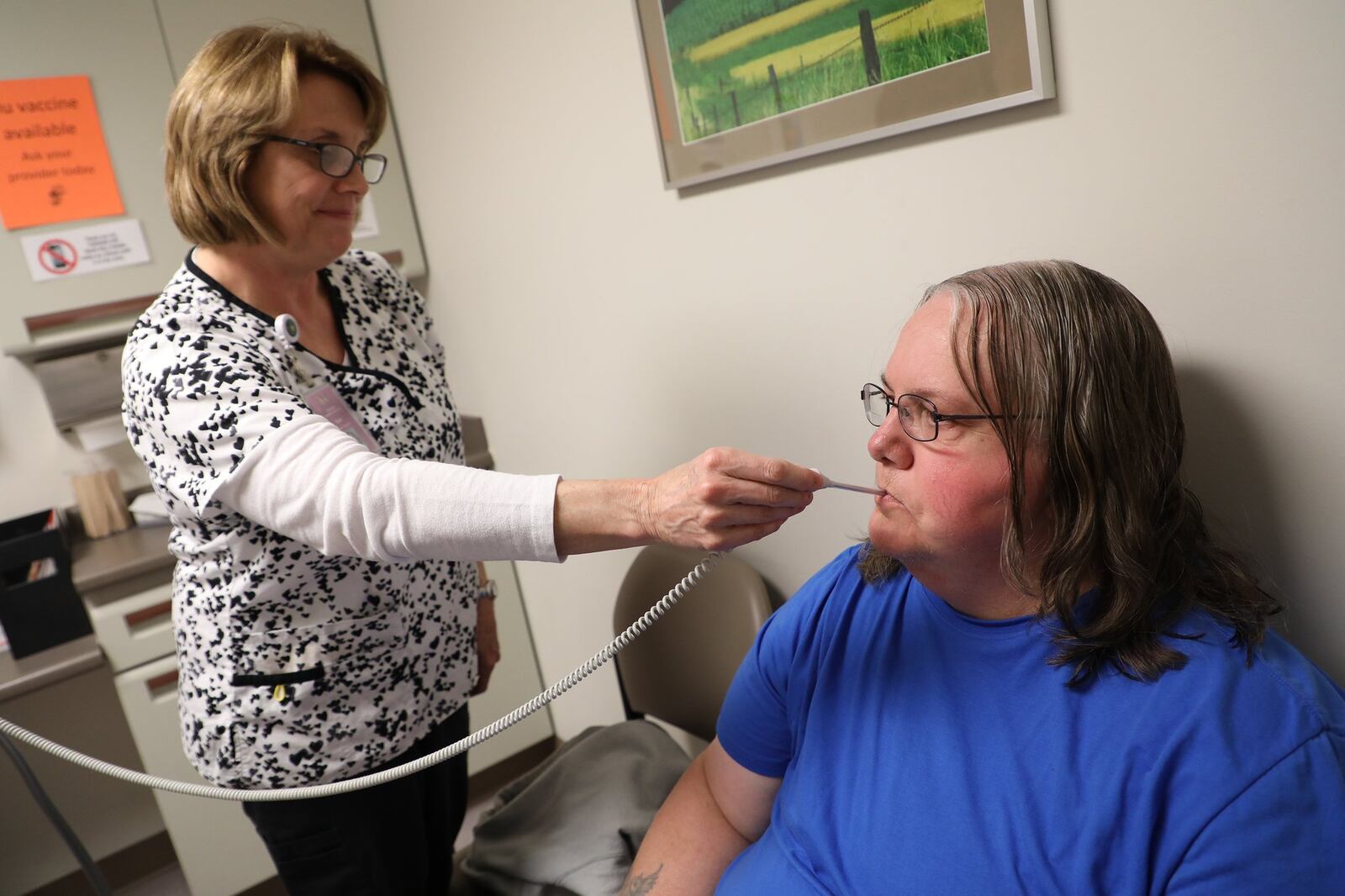 Beth Neville, a nurse at the Rocking Horse Center, takes Melissa Pope’s temperature during her visit Thursday. BILL LACKEY/STAFF