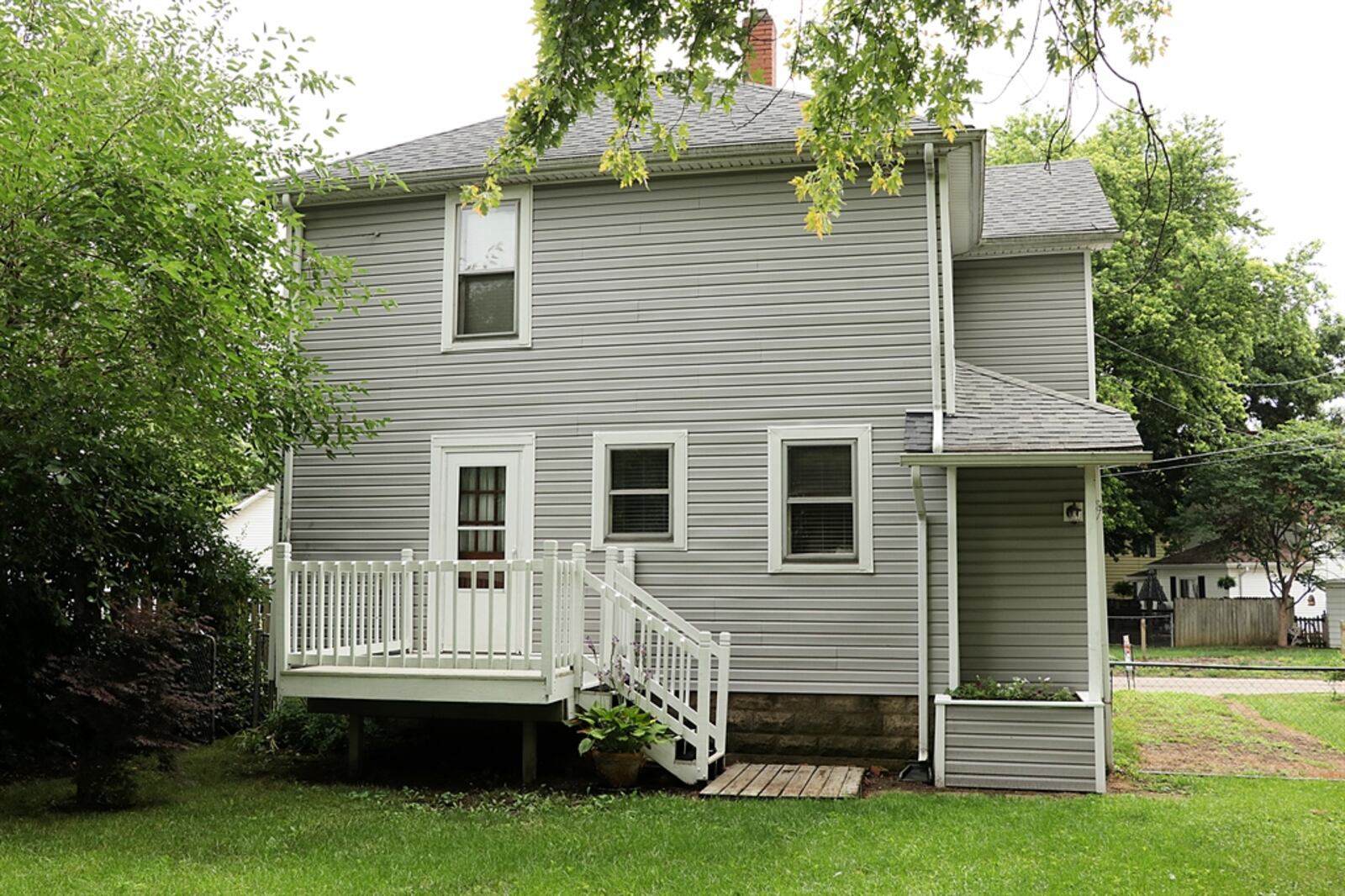 Exterior updates to the roof, gutters and siding were made in 2012 with the porch getting a white vinyl railing, composite wood steps and painted support columns. Some of the wood-pane windows have storm windows and the front door has the original door bell. The house has several garden beds, a fenced back yard with oversized gate, and a semi-private back yard with storage shed. Inside, the updated kitchen has granite countertops including an island and a butler’s pantry with the original cabinetry. Kathy Tyler/CONTRIBUTED