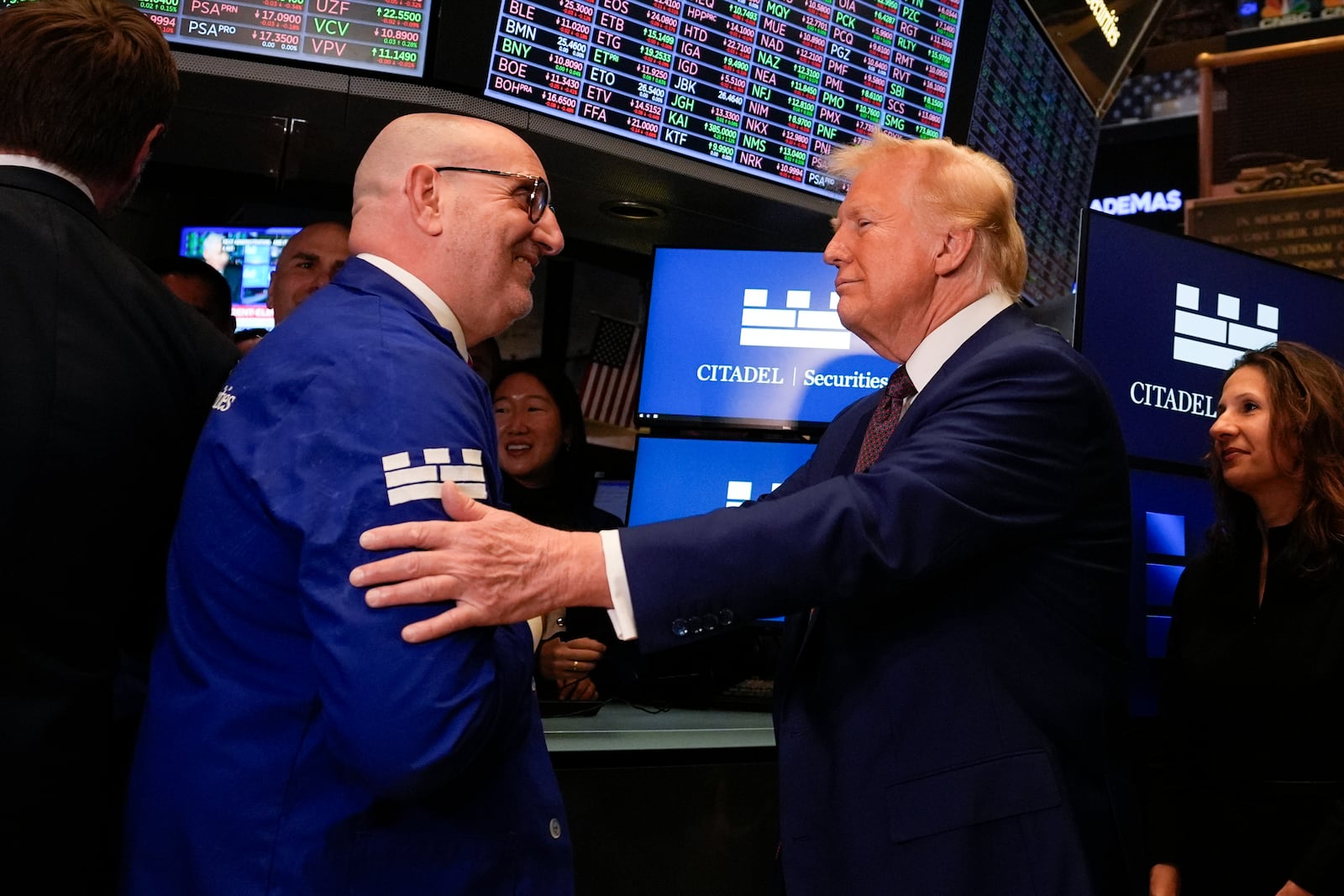 President-elect Donald Trump speaks with trader Peter Giacchi, as he walks the floor of the New York Stock Exchange, Thursday, Dec. 12, 2024, in New York. (AP Photo/Alex Brandon)