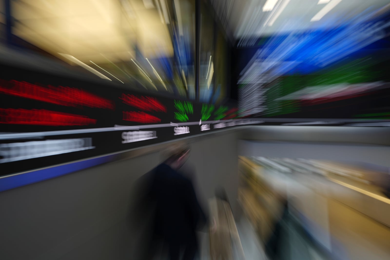 FTSE market information is displayed inside the London Stock Exchange, in the City of London, Monday, March 17, 2025. (AP Photo/Kin Cheung)