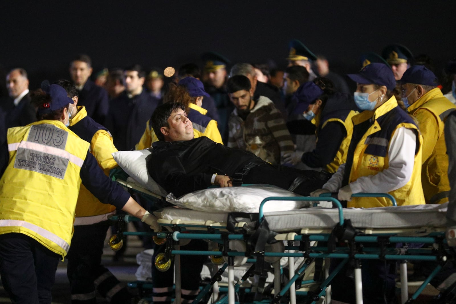 Wounded passengers of the Azerbaijani Airline's plane crashed near the Kazakhstani city of Aktau, are transported from a medical plane at the Heydar Aliyev International Airport outside Baku, Azerbaijan, Thursday, Dec. 26, 2024. (AP Photo)