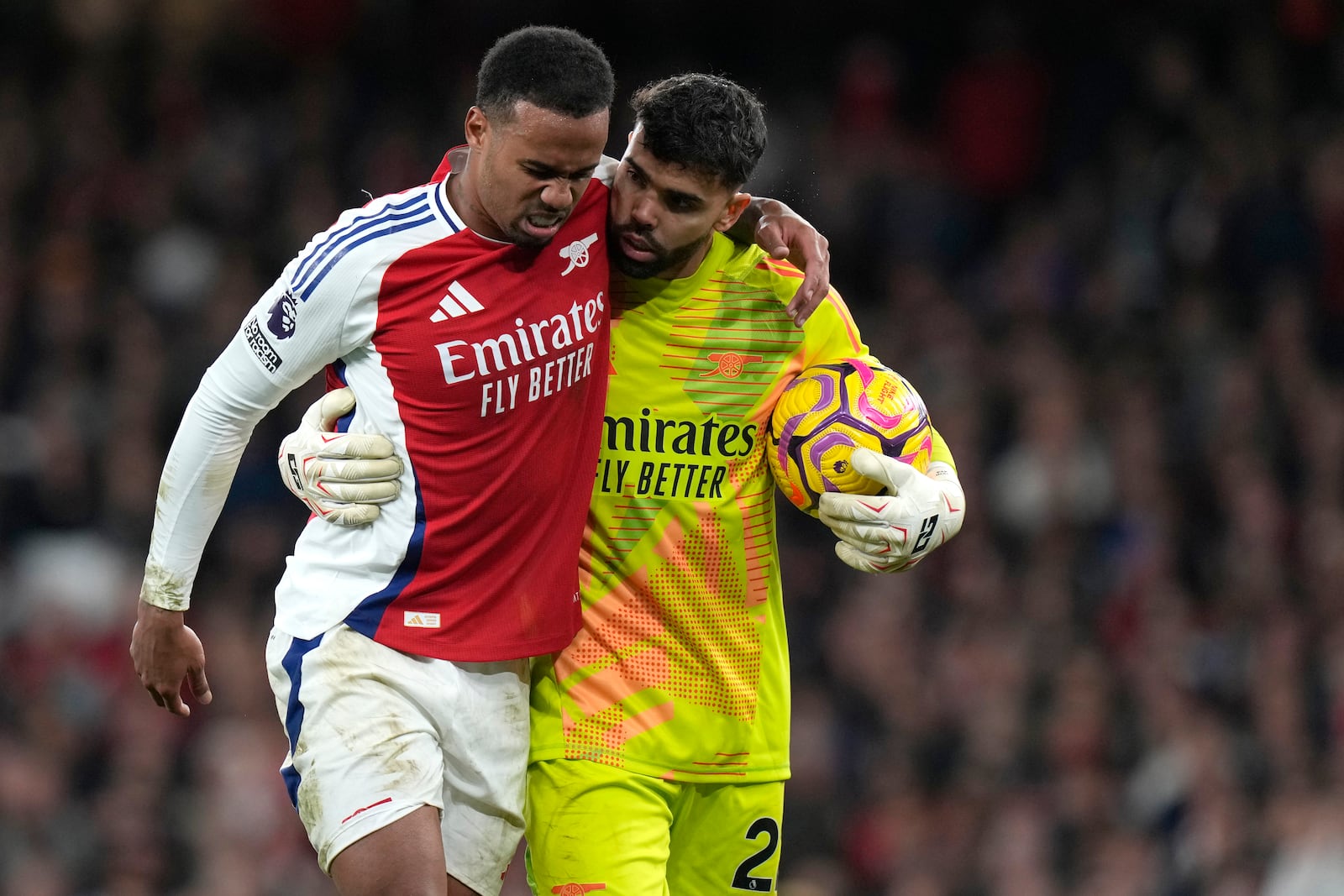 Arsenal's Gabriel, left, goes off injured with help of Arsenal's goalkeeper David Raya during the English Premier League soccer match between Arsenal and Liverpool, at Emirates Stadium in London, England, Sunday, Oct. 27, 2024. (AP Photo/Alastair Grant)