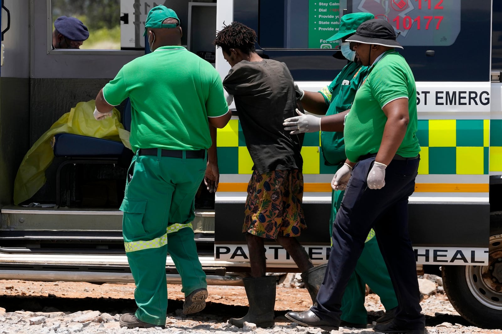 Rescuer workers assist an illegal miner who has been trapped deep in an abandoned gold mine for months, in Stilfontein, South Africa, Tuesday, Jan. 14, 2025. (AP Photo/Themba Hadebe)