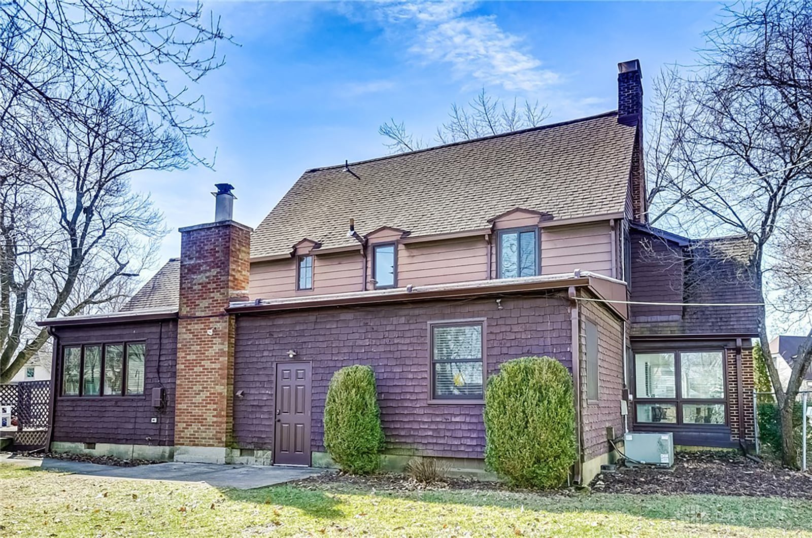 The rear of the home has a wood deck and a concrete patio.