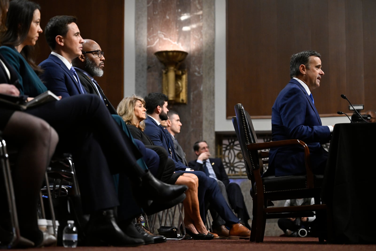 John Ratcliffe, seated right, President-elect Donald Trump's choice to be the Director of the Central Intelligence Agency, appears before the Senate Intelligence Committee for his confirmation hearing, at the Capitol in Washington, Wednesday, Jan. 15, 2025. (AP Photo/John McDonnell)