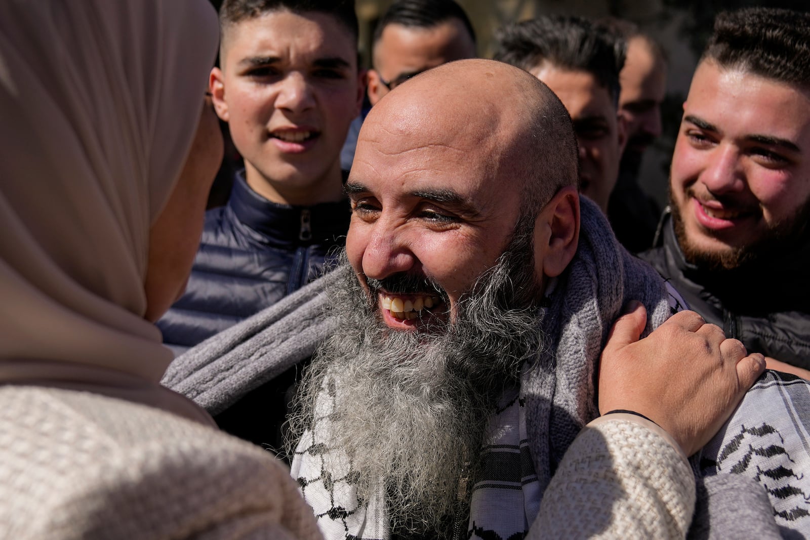 Palestinian prisoner Waddeh Bazrah, 43, right, is greeted after being released from Israeli prison following a ceasefire agreement between Israel and Hamas, in the West Bank city of Ramallah, Saturday, Feb. 15, 2025. (AP Photo/Nasser Nasser)