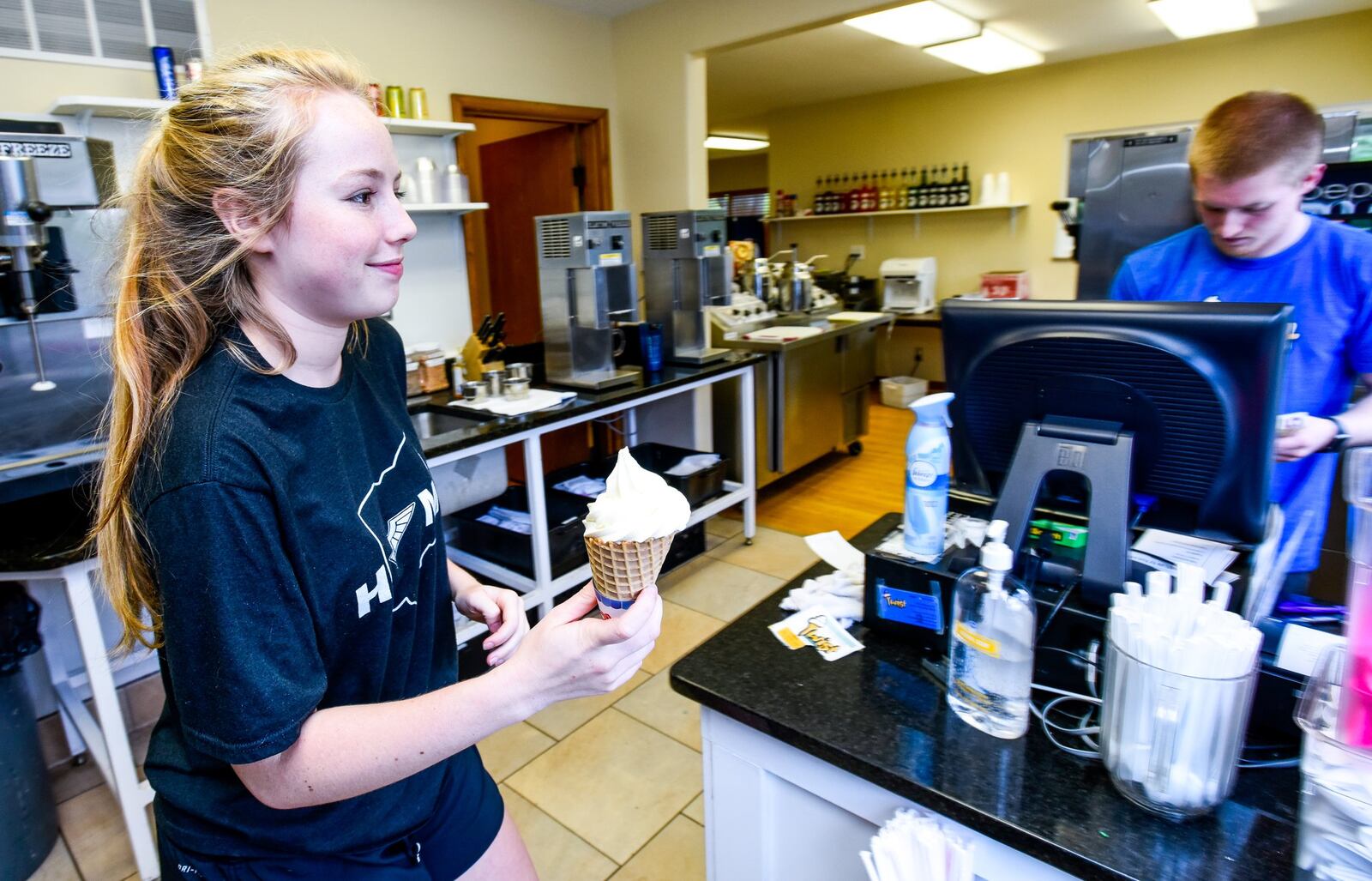 Kate Harvey, 16,serves an ice cream cone during her shift at Twist Ice Cream Company Wednesday, May 31, 2017, on Bethany Road in Liberty Twp. NICK GRAHAM/STAFF