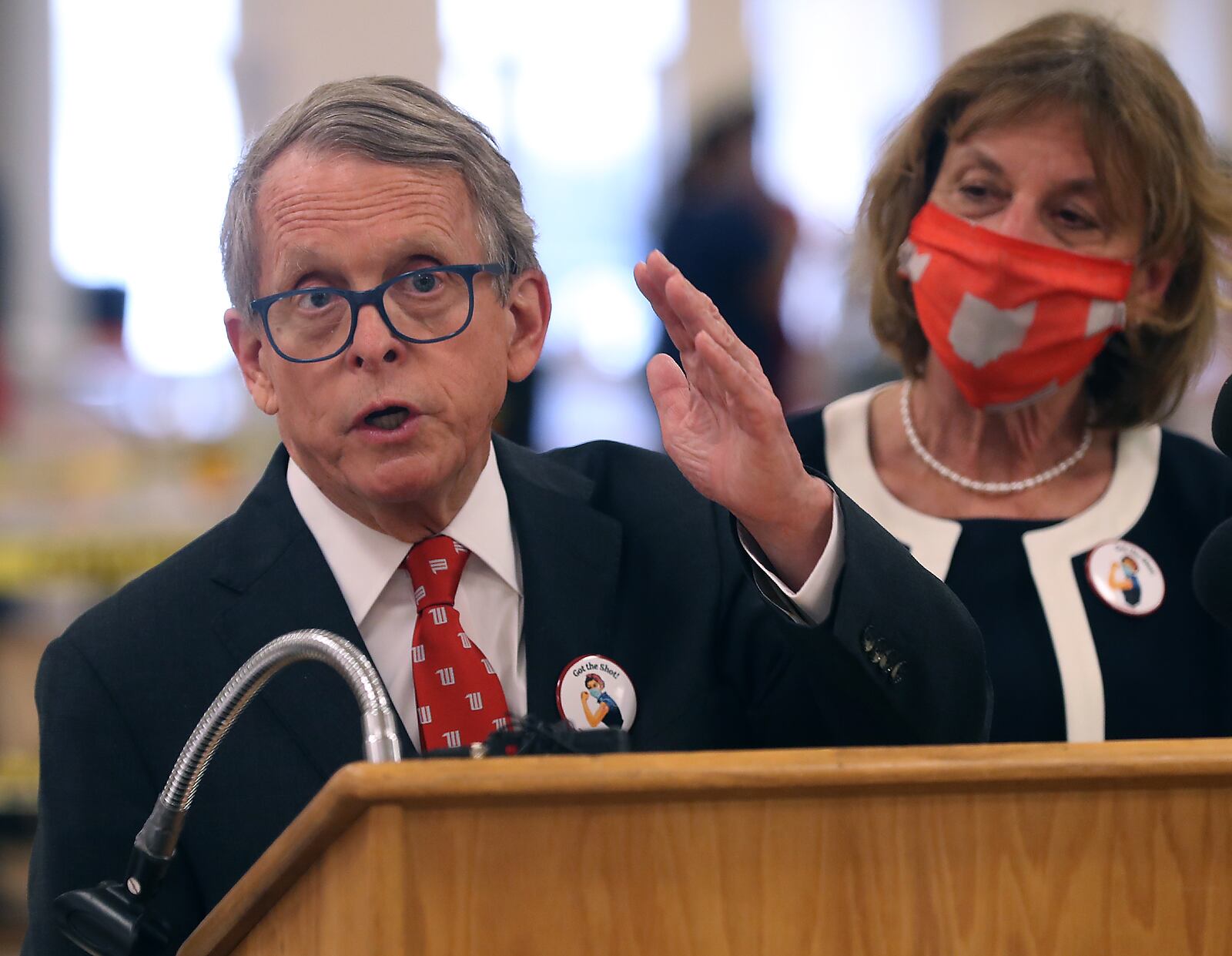 Governor Mike DeWine speaks to the media after touring the Clark County COVID vaccine distribution center with his wife, Fran, at the Upper Valley Mall Thursday. BILL LACKEY/STAFF