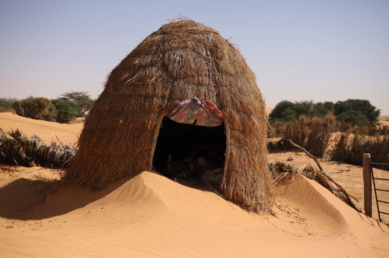 A hut is surrounded by sand in Chinguetti, Mauritania on Feb. 4, 2025. (AP Photo/Khaled Moulay)