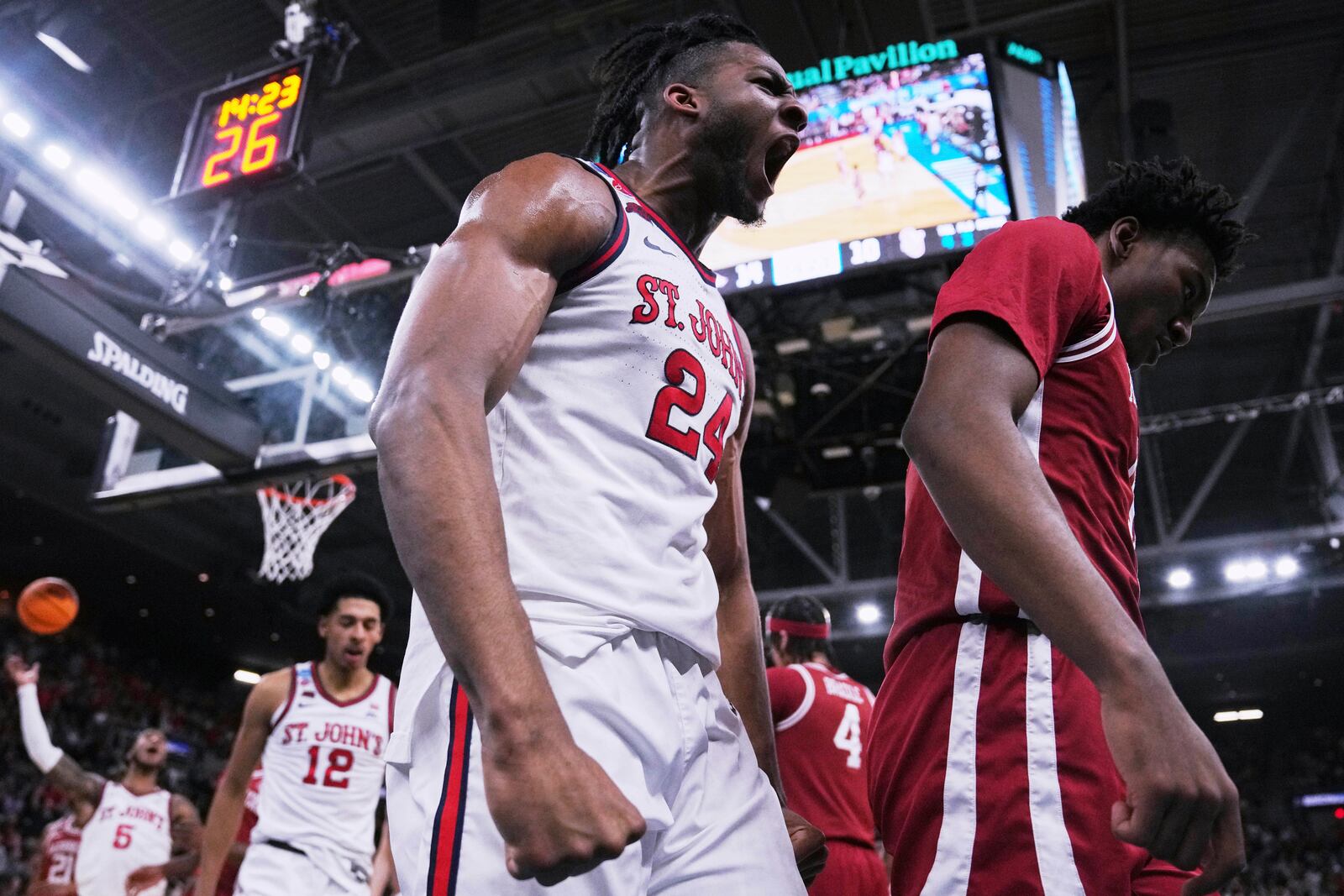 St. John's forward Zuby Ejiofor (24) celebrates after scoring against Arkansas during the first half in the second round of the NCAA college basketball tournament, Saturday, March 22, 2025, in Providence, R.I. (AP Photo/Charles Krupa)