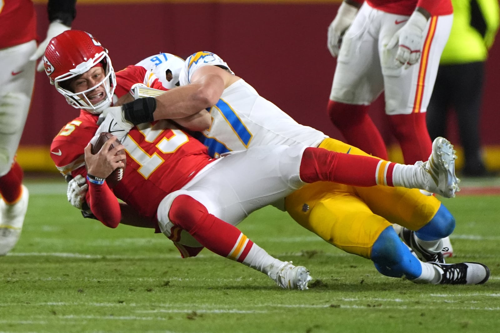 FILE - Kansas City Chiefs quarterback Patrick Mahomes, left, is sacked by Los Angeles Chargers linebacker Joey Bosa during the first half of an NFL football game, Dec. 8, 2024, in Kansas City, Mo. (AP Photo/Charlie Riedel, File)