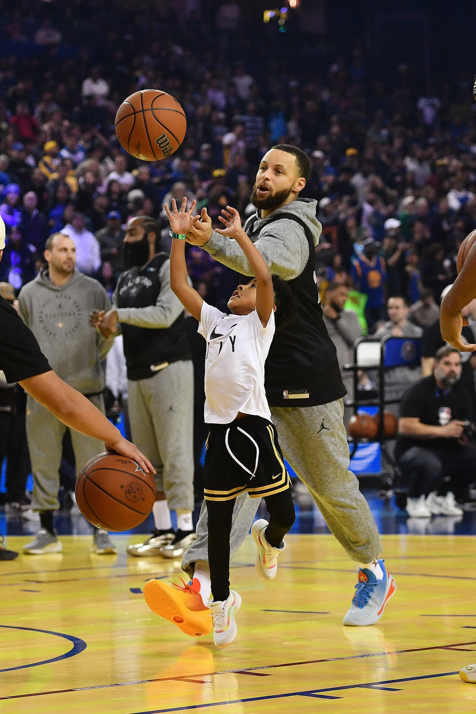 Golden State Warriors' Stephen Curry plays basketball with a child during practice for the NBA All-Star basketball game, Saturday, Feb. 15, 2025, in Oakland, Calif. (Jose Carlos Fajardo/Bay Area News Group via AP)