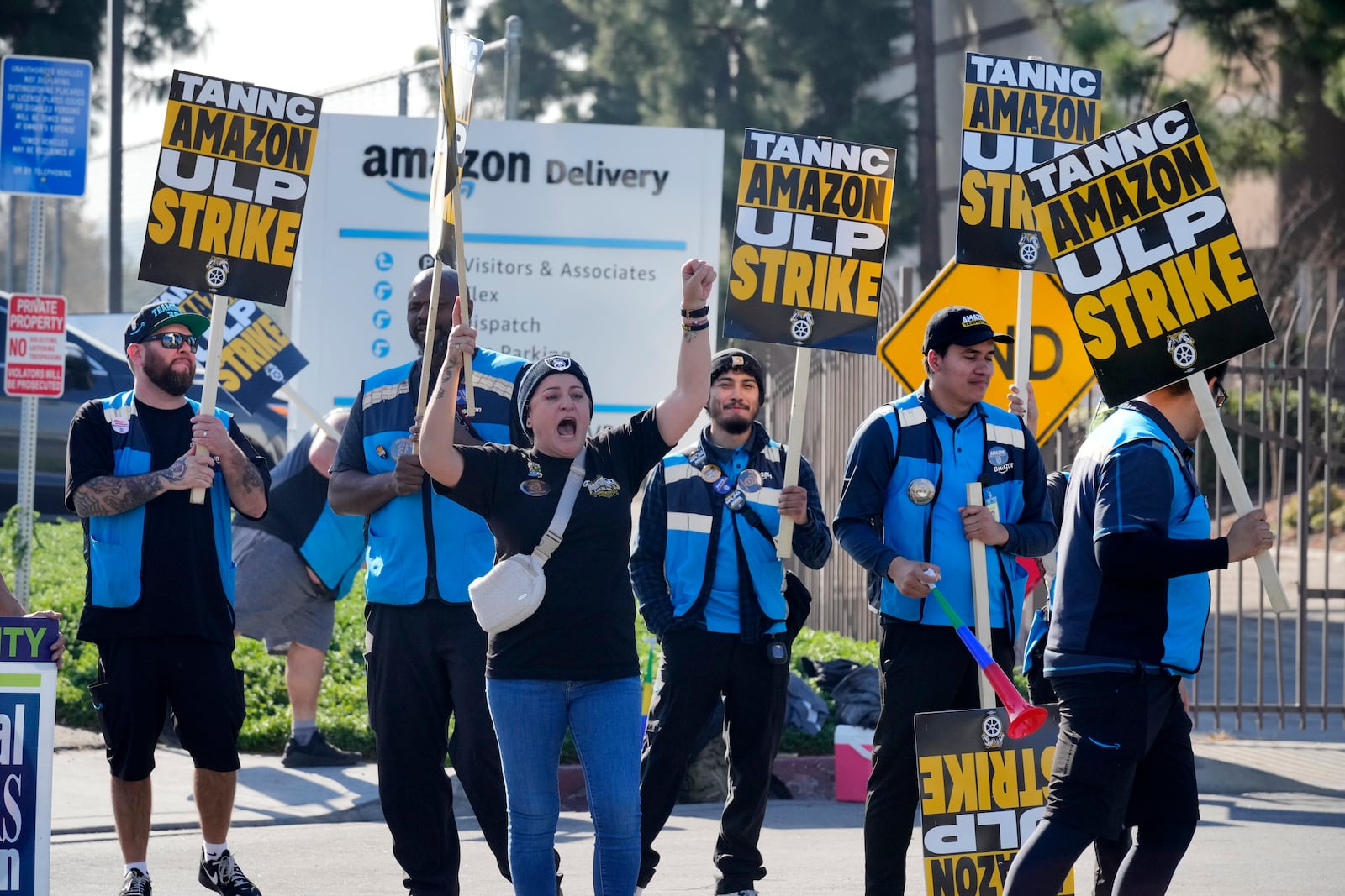 Amazon workers strike outside the gates of an Amazon Fulfillment Center as Teamsters seek labor contract nationwide Friday, Dec. 20, 2024, in City of Industry, Calif. (AP Photo/Damian Dovarganes)