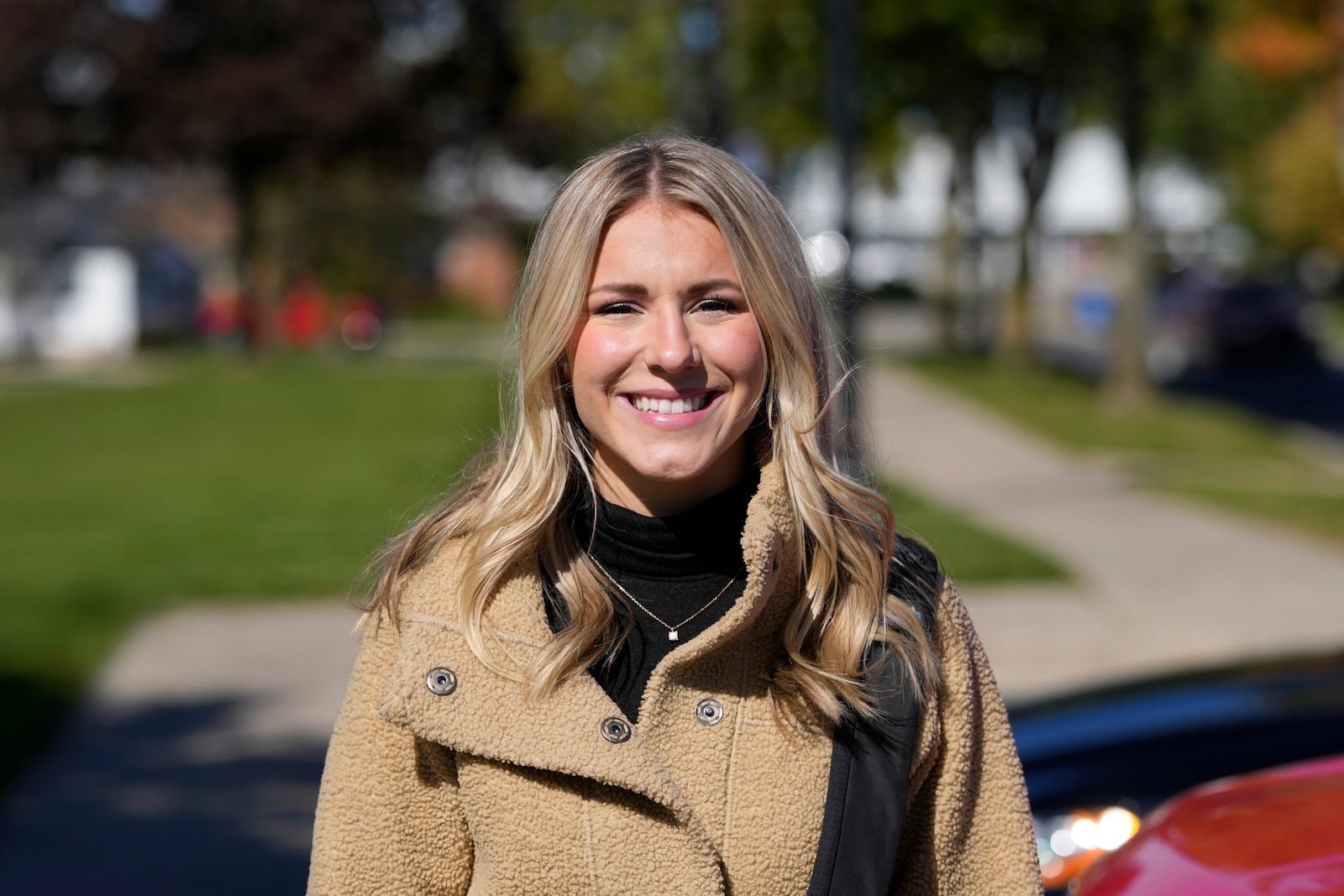 Republican Rylee Linting goes door to door campaigning hoping to unseat Democratic State Rep. Jaime Churches, Wednesday, Oct. 16, 2024, in Gibraltar, Mich. (AP Photo/Carlos Osorio)