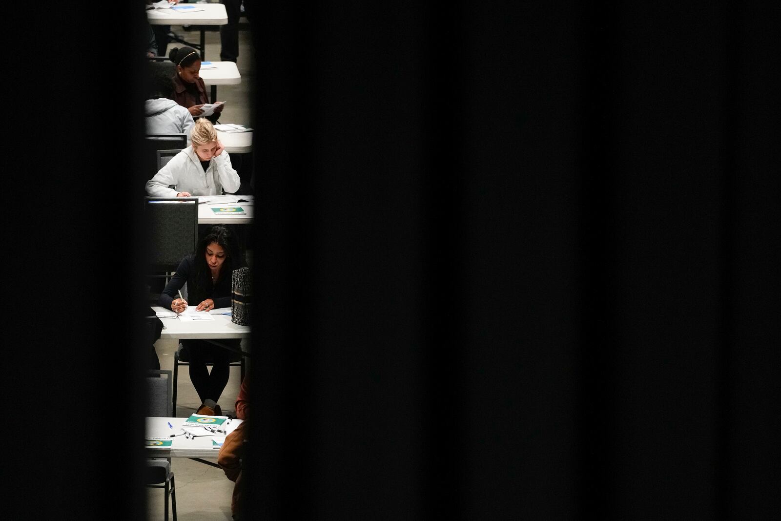 Voters fill out their ballots at a voting center at Lumen Field Event Center on Election Day, Tuesday, Nov. 5, 2024, in Seattle. (AP Photo/Lindsey Wasson)