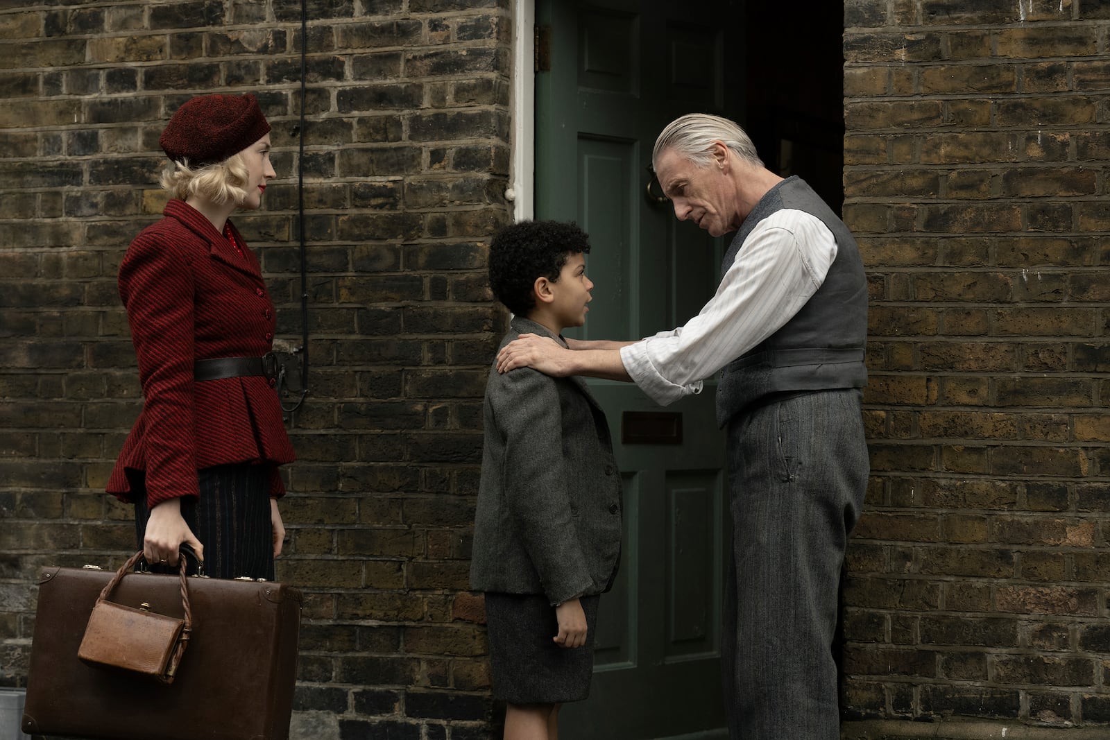 This image released by Apple TV+ shows Saoirse Ronan, from left, Elliott Heffernan, and Paul Weller in a scene from "Blitz." (Apple TV+ via AP)