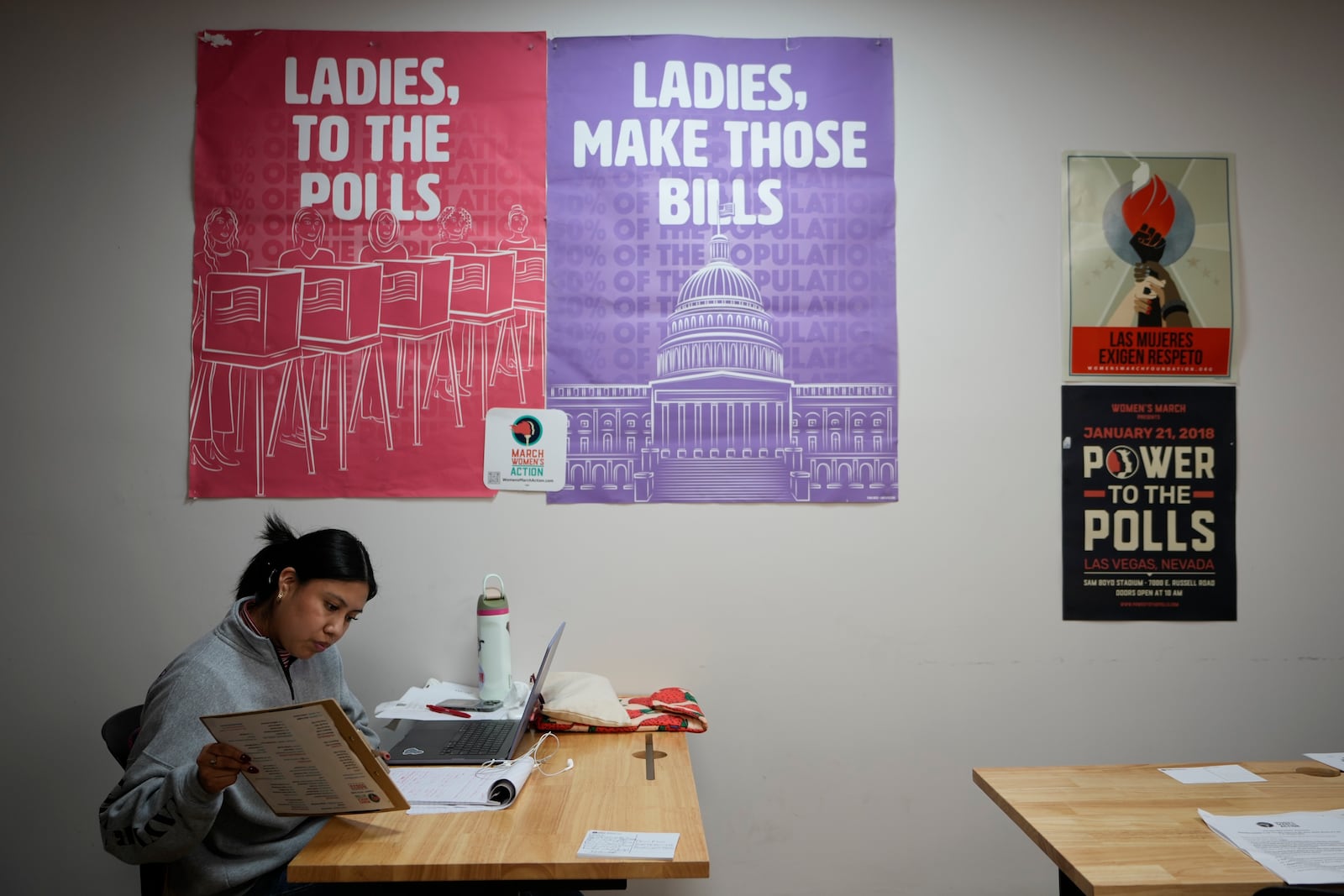 Mirian Palacios, volunteer and campaign manager, joins a group at a phone bank encouraging voters to vote for Vice President Kamala Harris in Los Angeles on Tuesday, Oct. 15, 2024. (AP Photo/Damian Dovarganes)