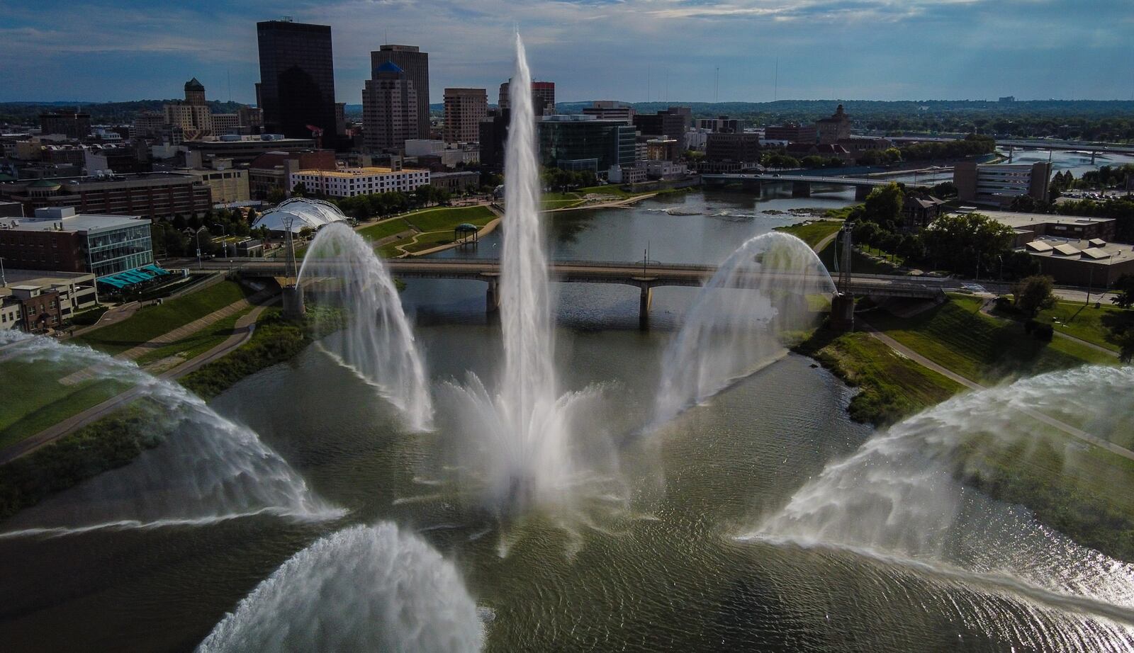 The downtown Dayton skyline is seen through the fountain spray Sept. 3, 2021, at Deeds Point MetroPark on Webster Street. JIM NOELKER/STAFF