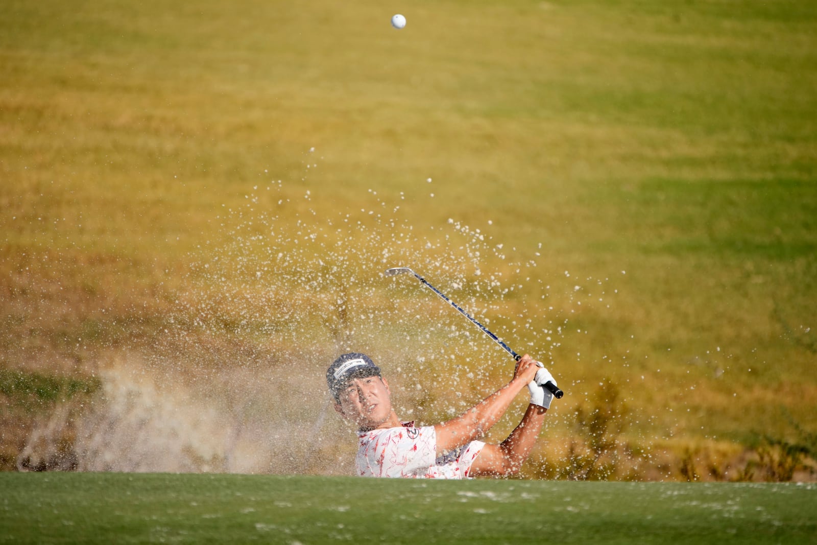 Justin Suh hits from a bunker on the third hole during the first round of Shriners Children's Open golf tournament Thursday, Oct. 17, 2024, in Las Vegas. (AP Photo/John Locher)