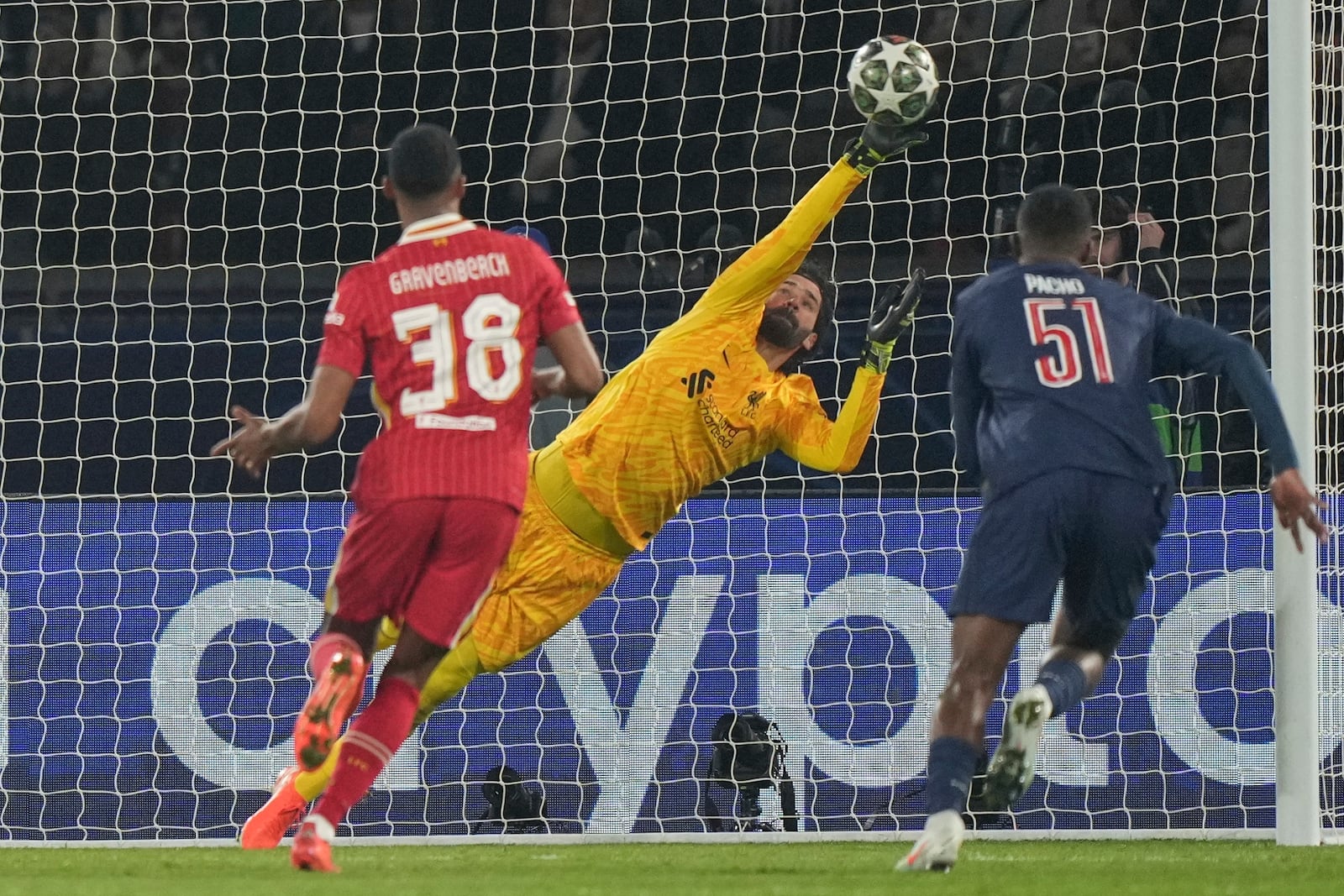 Liverpool's goalkeeper Alisson makes a save during the Champions League round of 16 first leg soccer match between Paris Saint-Germain and Liverpool at the Parc des Princes in Paris, Wednesday, March 5, 2025. (AP Photo/Aurelien Morissard)