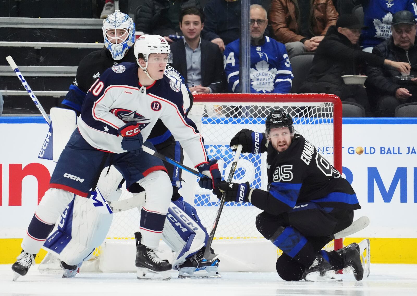 Toronto Maple Leafs goaltender Dennis Hildeby, Columbus Blue Jackets' Dmitri Voronkov (10) and Maple Leafs' Oliver Ekman-Larsson (95) look for the puck during the second period of an NHL hockey game in Toronto on Wednesday, Jan. 22, 2025. (Frank Gunn/The Canadian Press via AP)