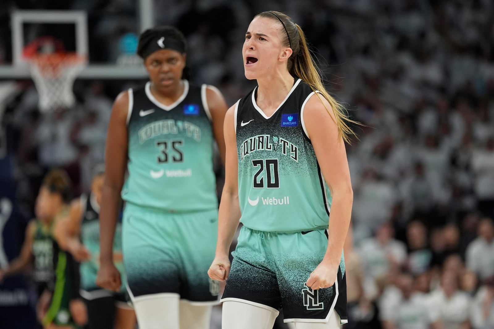 New York Liberty guard Sabrina Ionescu (20) reacts after making a three-point basket during the second half against the Minnesota Lynx in Game 3 of a WNBA basketball final playoff series, Wednesday, Oct. 16, 2024, in Minneapolis. (AP Photo/Abbie Parr)