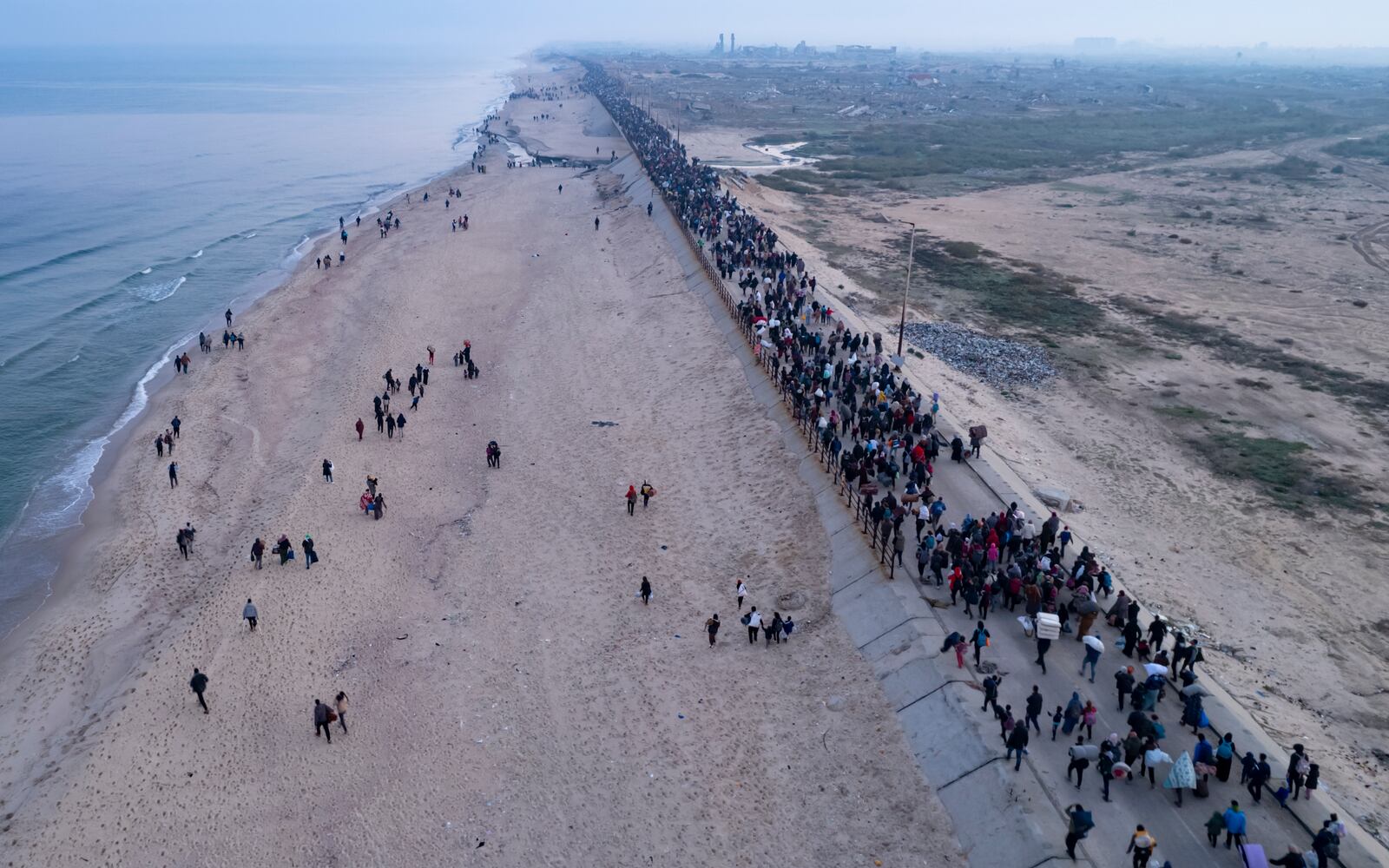 An aerial photograph taken by a drone shows displaced Palestinians return to their homes in the northern Gaza Strip, following Israel's decision to allow thousands of them to go back for the first time since the early weeks of the 15-month war with Hamas, Monday, Jan. 27, 2025. (AP Photo/ Mohammad Abu Samra)