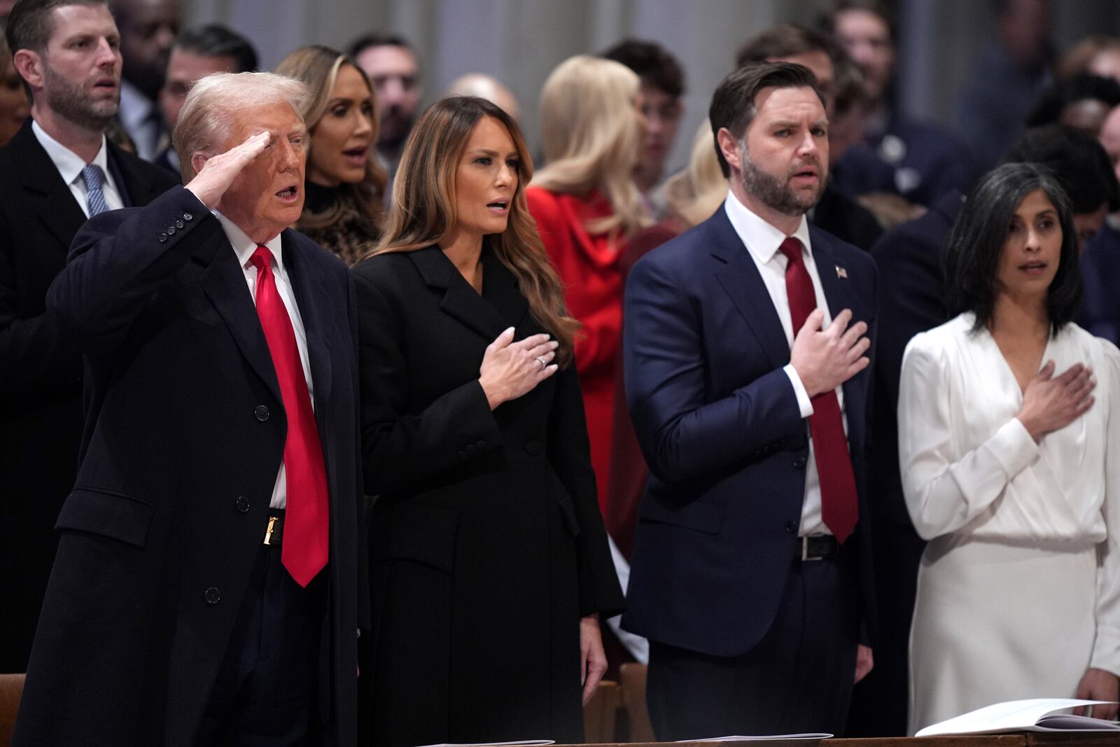 President Donald Trump, from left, salutes alongside first lady Melania Trump, Vice President JD Vance and his wife Usha Vance during the national prayer service at the Washington National Cathedral, Tuesday, Jan. 21, 2025, in Washington. (AP Photo/Evan Vucci)