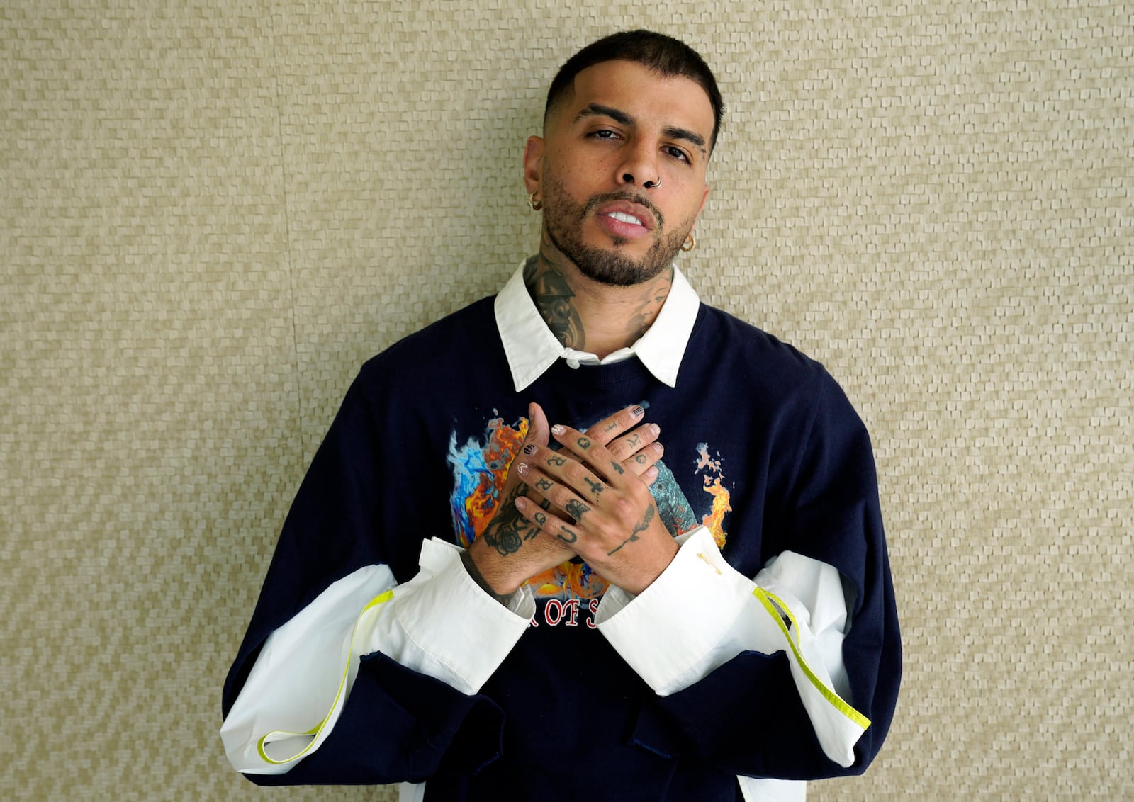 FILE - Singer/rapper Rauw Alejandro poses for a portrait at the Aria Hotel in Las Vegas on Nov. 18, 2021. (AP Photo/Chris Pizzello, File)