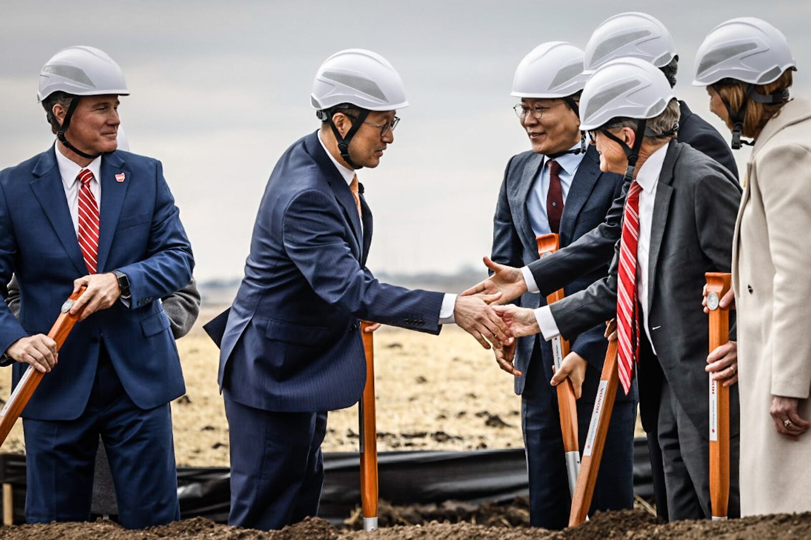 JV company CEO, Robert Lee, left center,  shakes the hand of Ohio Gov. Mike DeWine after the groundbreaking of the new EV battery plant near Jeffersonville Tuesday February 28, 2023. JIM NOELKER/STAFF