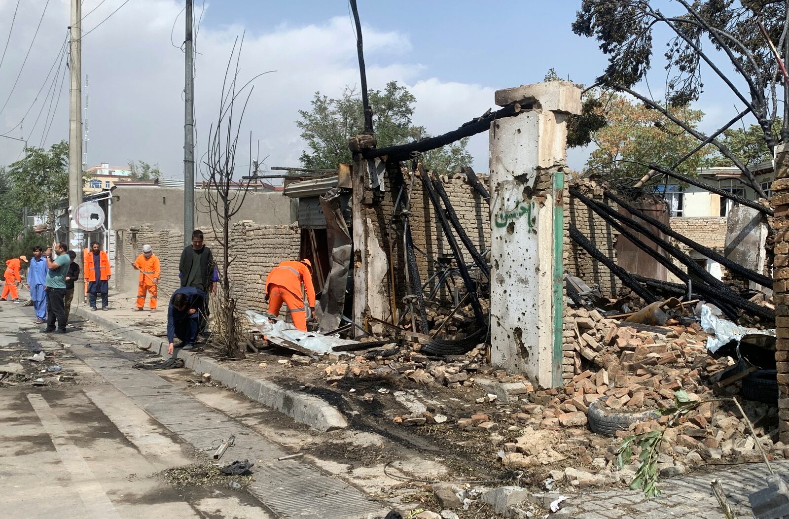 Afghan Municipality workers work at the site of an explosion in Kabul, Afghanistan, Wednesday, Sept. 9, 2020. Afghanistan’s Interior Ministry said the bombing in Kabul targeting the convoy of the country’s first vice president killed many people and wounded more than a dozen others, including several of the vice president’s bodyguards. First Vice President Amrullah Saleh suffered minor burns in the attack on Wednesday morning. (AP Photo/Rahmat Gul)