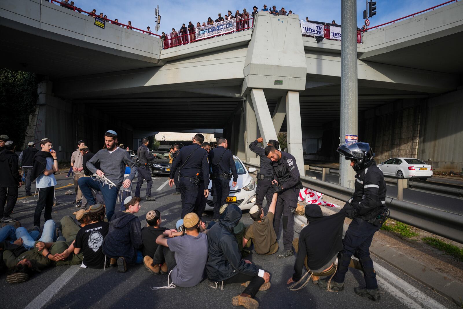 Police disperse demonstrators who are blocking a road during a protest against the ceasefire deal between Israel and Hamas in Jerusalem on Thursday, Jan. 16, 2025. (AP Photo/Ohad Zwigenberg)