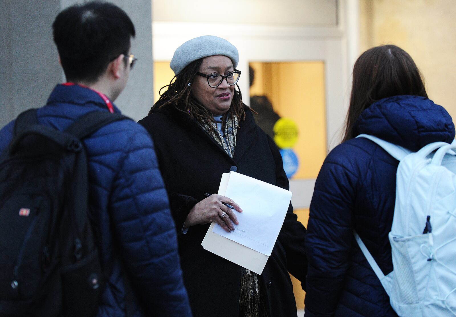 University of Dayton professor Rochonda Nenonene talks with students getting ready to board buses to go student teach at local schools Tuesday Feb. 7, 2023. MARSHALL GORBY\STAFF