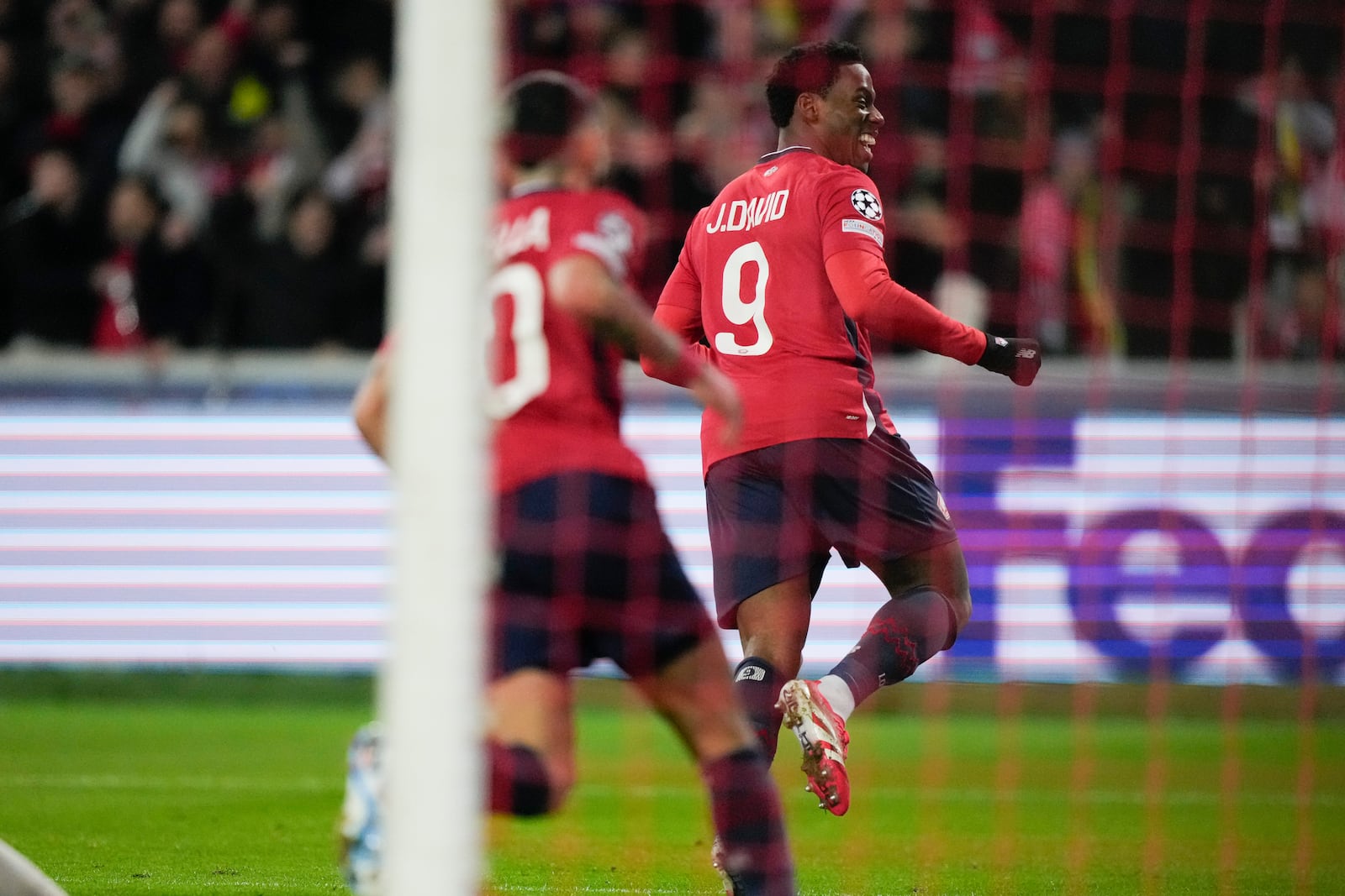 Lille's Jonathan David celebrates after scoring during the Champions League round of 16 second leg soccer match between Lille and Borussia Dortmund in Villeneuve-d'Ascq , Wednesday, March 12, 2025. (AP Photo/Michel Euler)